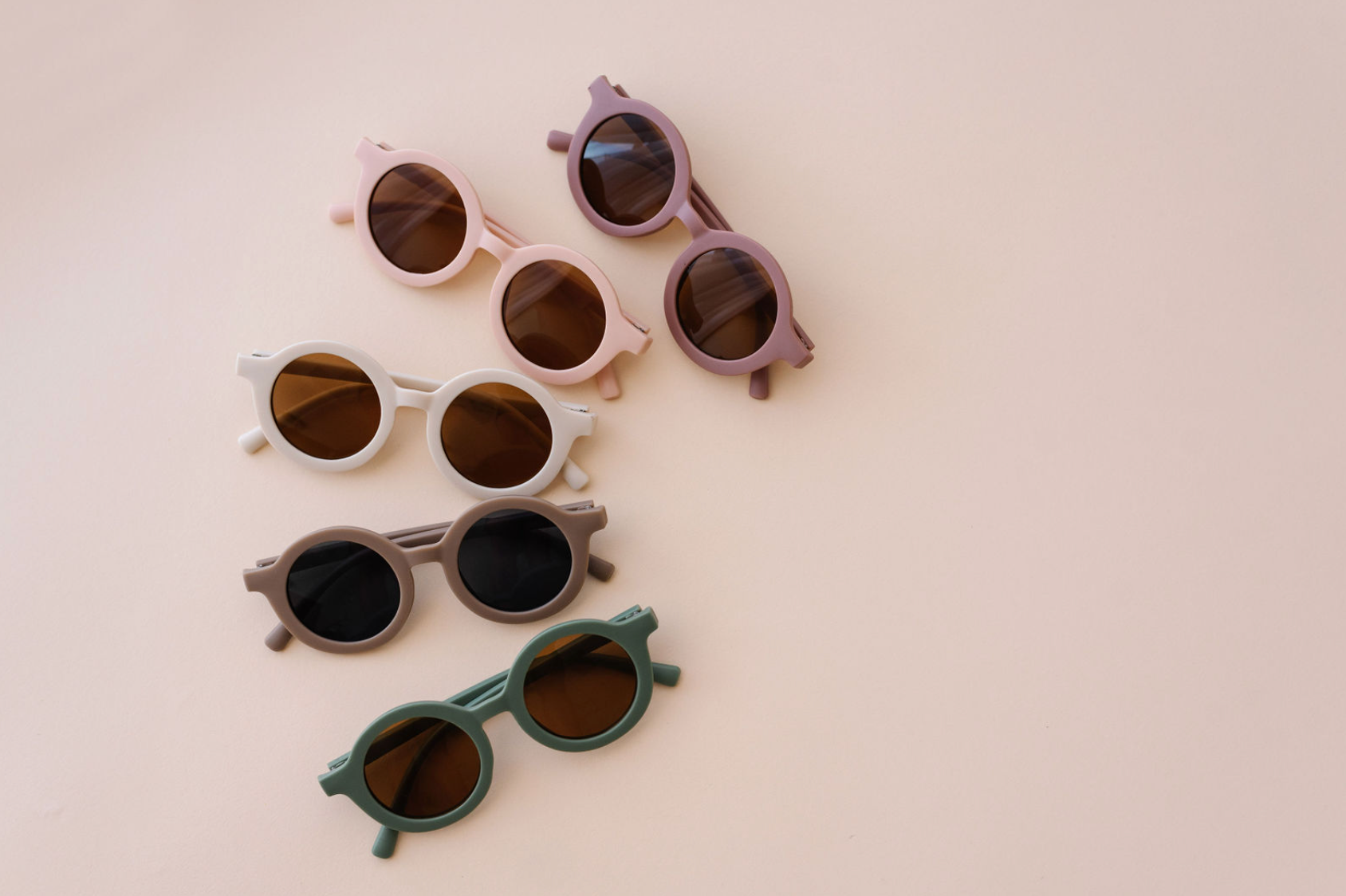 Colorful baby sunglasses designed for children aged 2-5 years, featuring lightweight frames and UV protection.