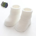 A pair of baby thickened soft cotton anti-slip floor socks in solid color, designed for comfort and safety.