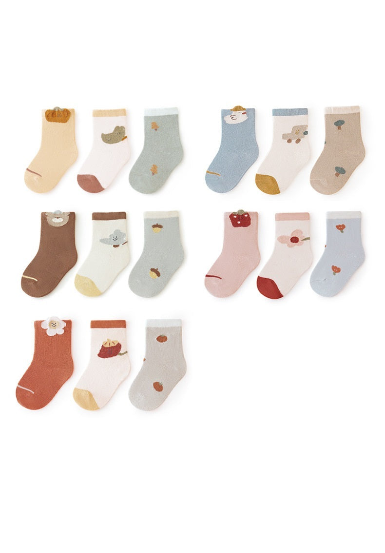 A colorful set of baby unisex cartoon socks in various colors including white, pink, light blue, apricot, and coffee, designed for comfort and style.