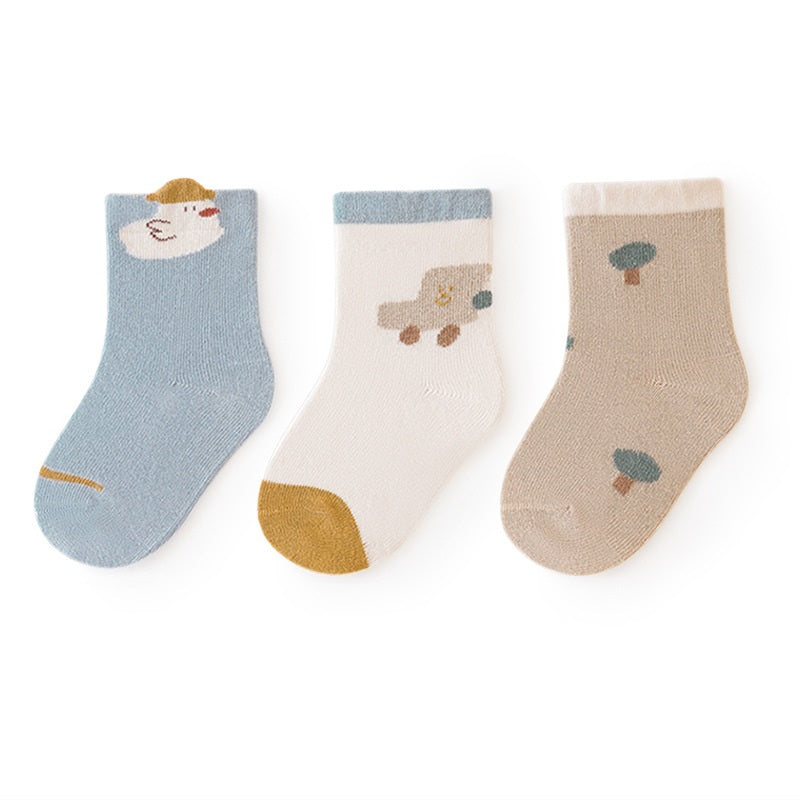 A colorful set of baby unisex cartoon socks in various colors including white, pink, light blue, apricot, and coffee, designed for comfort and style.