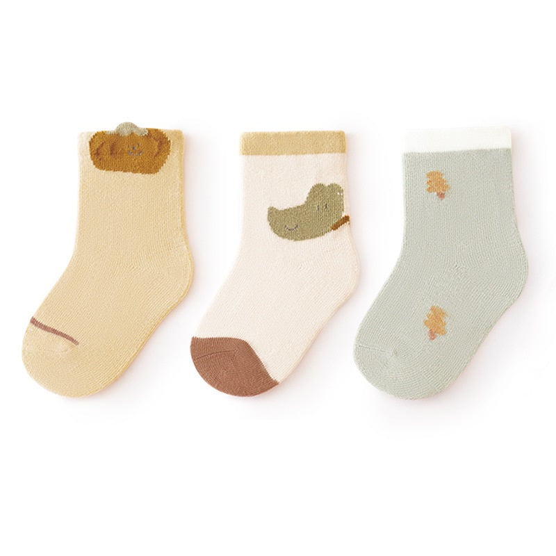 A colorful set of baby unisex cartoon socks in various colors including white, pink, light blue, apricot, and coffee, designed for comfort and style.