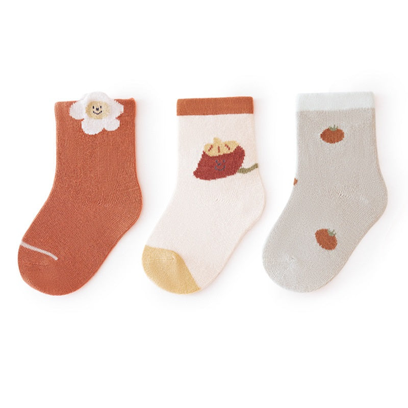 A colorful set of baby unisex cartoon socks in various colors including white, pink, light blue, apricot, and coffee, designed for comfort and style.