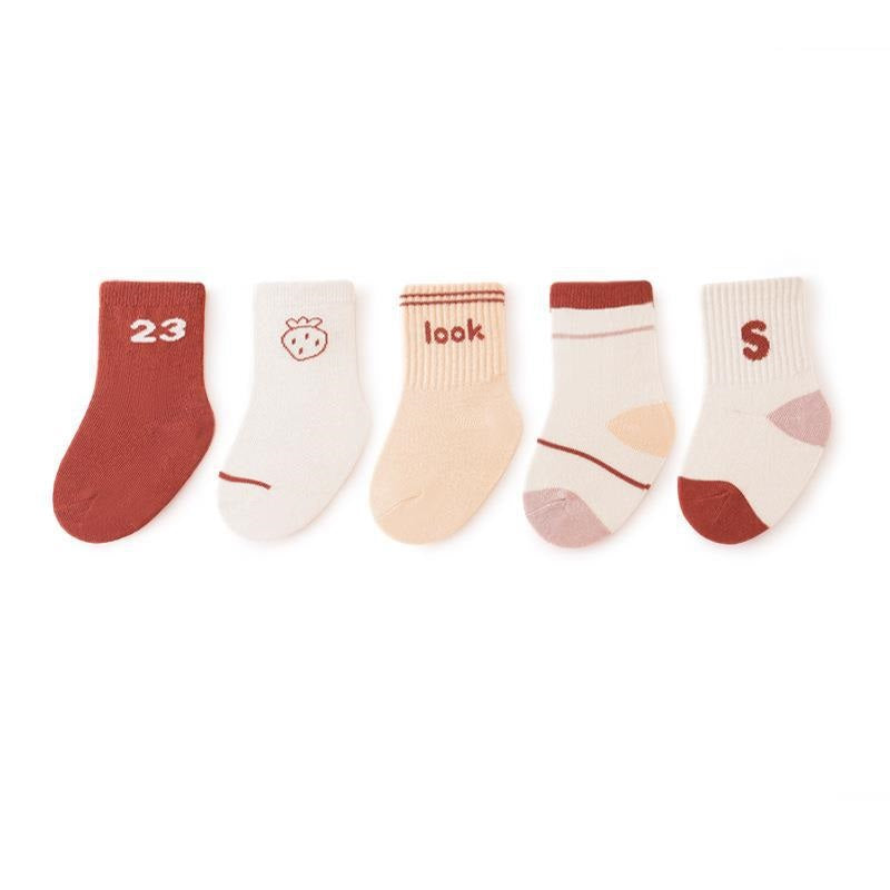 A colorful set of five pairs of baby socks in red, navy blue, blue, yellow, and grey, featuring fun patterns like stripes and cartoons.