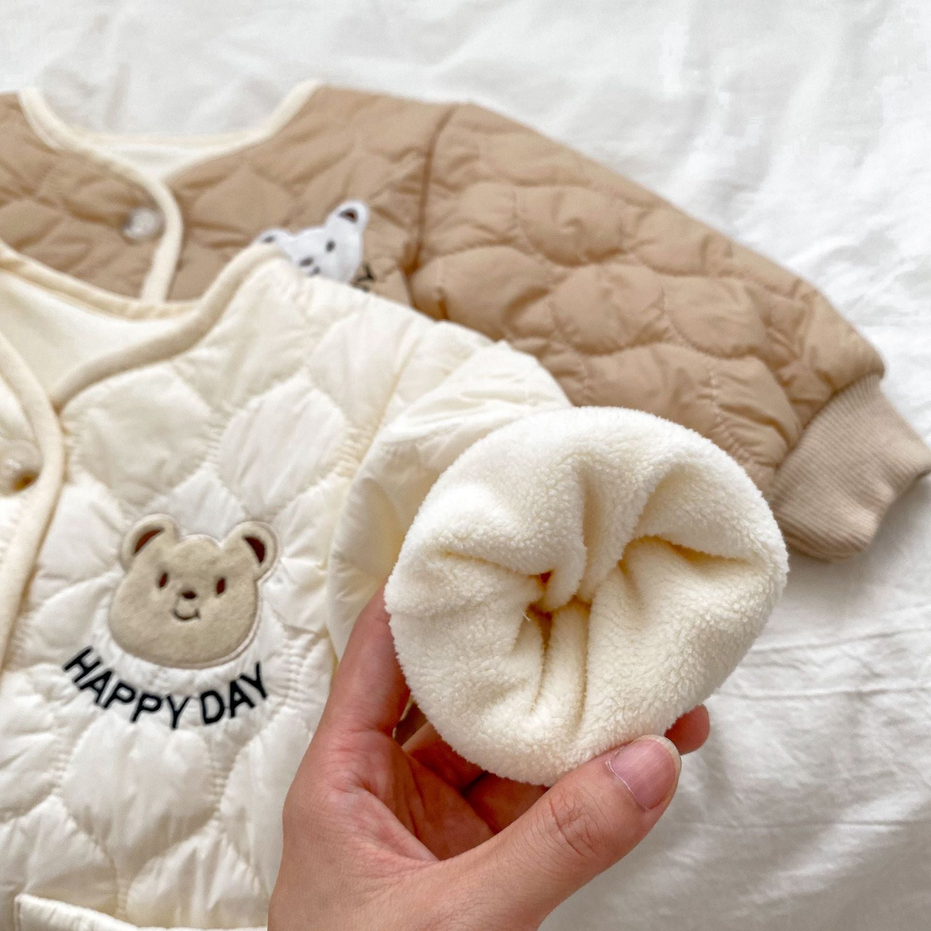 Baby unisex outfit featuring a thick warm long sleeve top with a bear head design and matching pants in white and khaki colors.