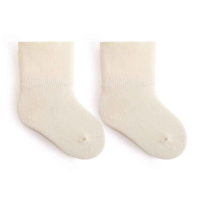 A pair of Baby Unisex Solid Color Breathable Mid-Calf Socks in various colors including white, grey, khaki, beige, and apricot, showcasing their soft fabric and mid-calf length.