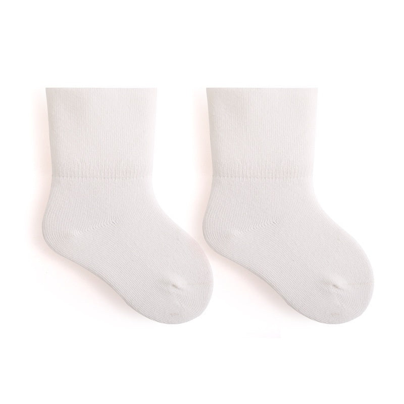 A pair of Baby Unisex Solid Color Breathable Mid-Calf Socks in various colors including white, grey, khaki, beige, and apricot, showcasing their soft fabric and mid-calf length.