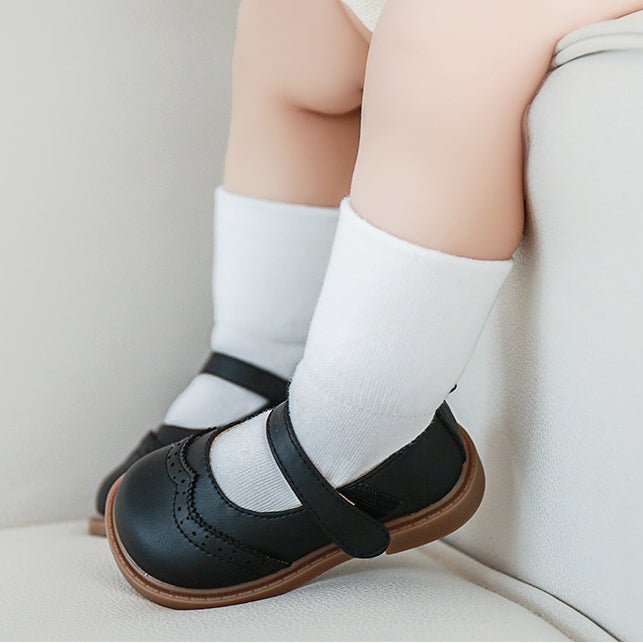 A pair of Baby Unisex Solid Color Breathable Mid-Calf Socks in various colors including white, grey, khaki, beige, and apricot, showcasing their soft fabric and mid-calf length.