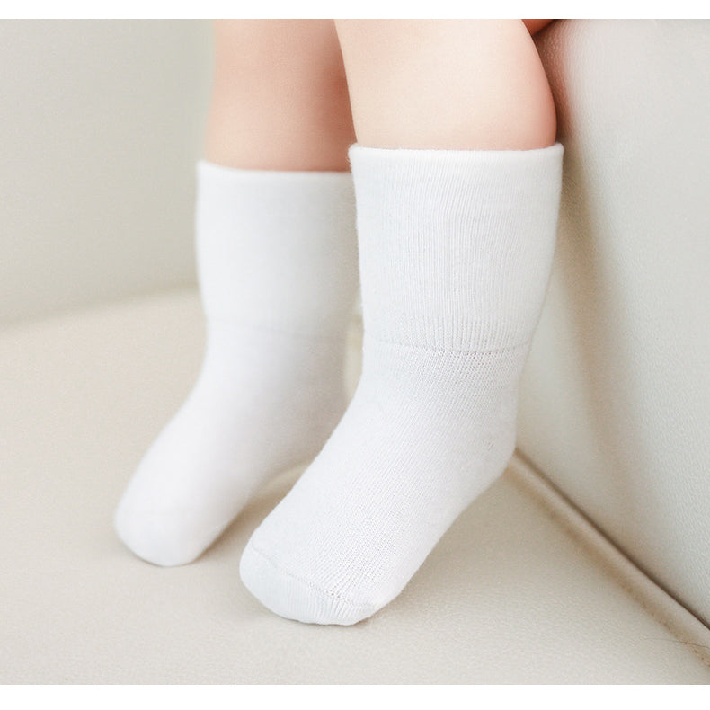 A pair of Baby Unisex Solid Color Breathable Mid-Calf Socks in various colors including white, grey, khaki, beige, and apricot, showcasing their soft fabric and mid-calf length.