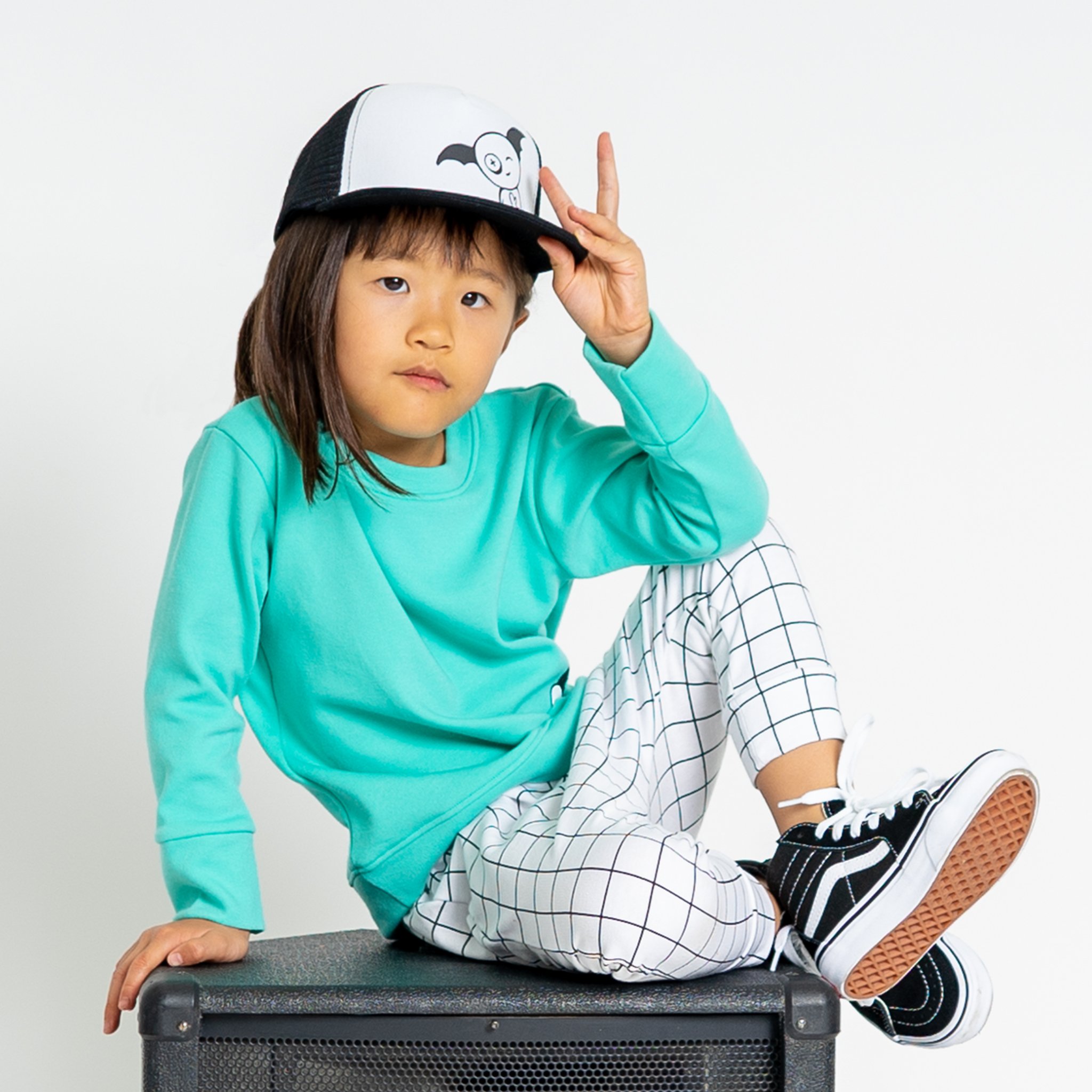 Bae Snapback Trucker Cap for kids, featuring adjustable snapback, breathable mesh, and cotton material in a stylish design.