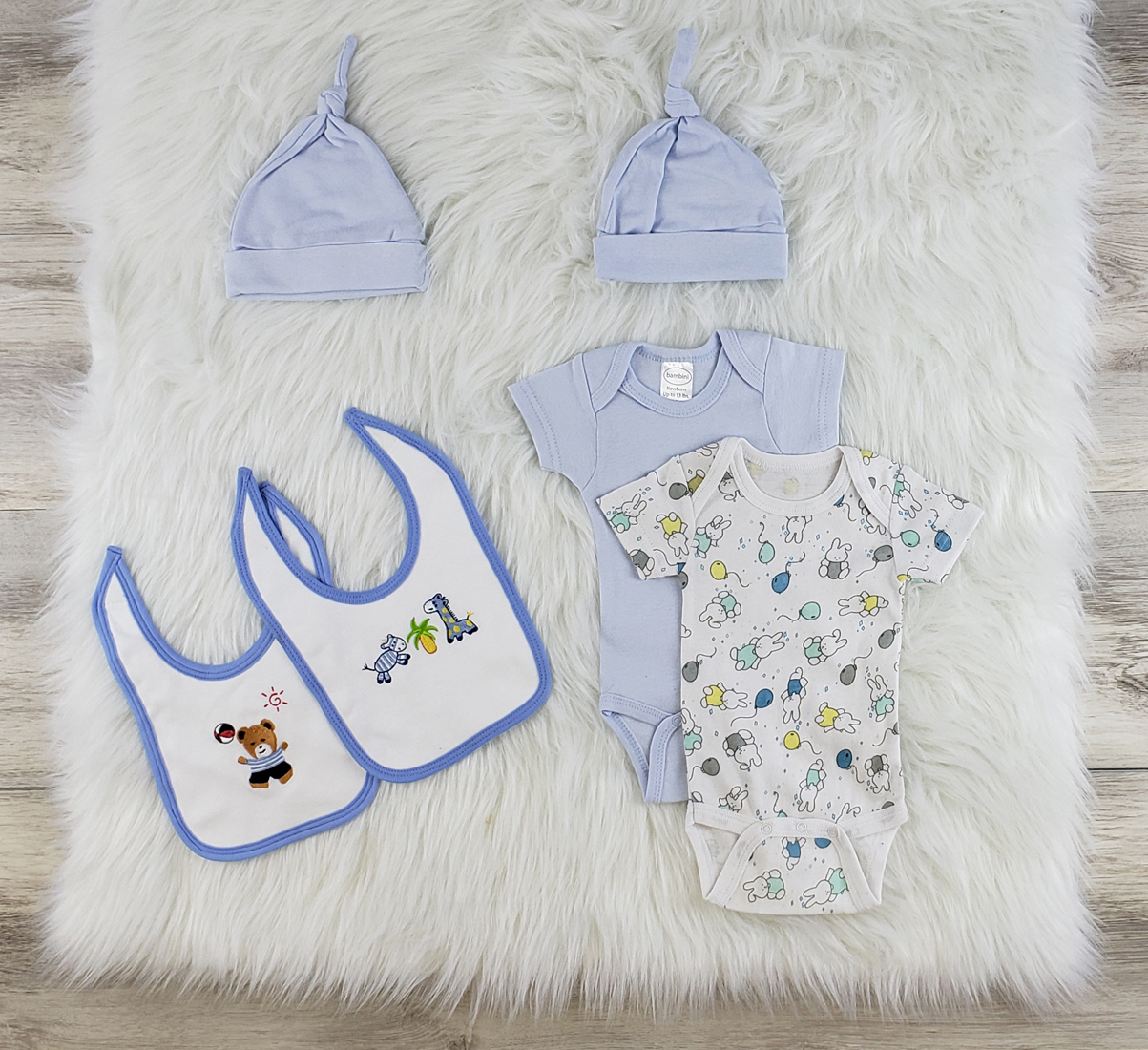 Bambini 6 Pc Layette Baby Clothes Set featuring soft cotton onesies, bibs, and knotted caps in blue and white.