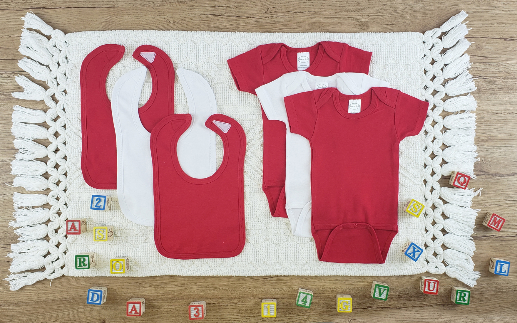 Bambini 6 Pc Layette Baby Clothes Set featuring soft cotton onesies and bibs in red and white, perfect for newborns.