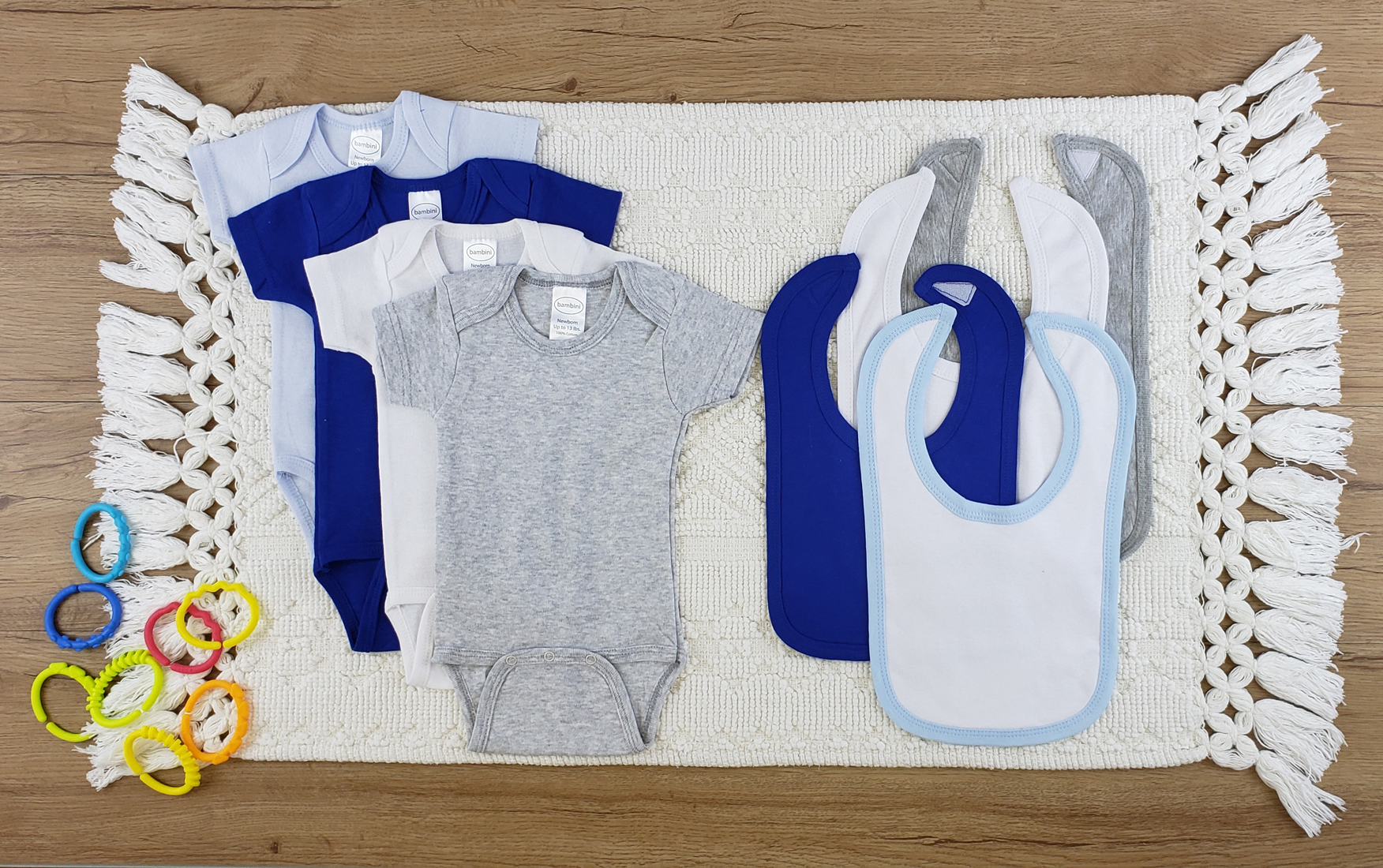 Bambini 8 Pc Layette Baby Clothes Set featuring soft cotton bibs and onesies in various colors, perfect for newborns.