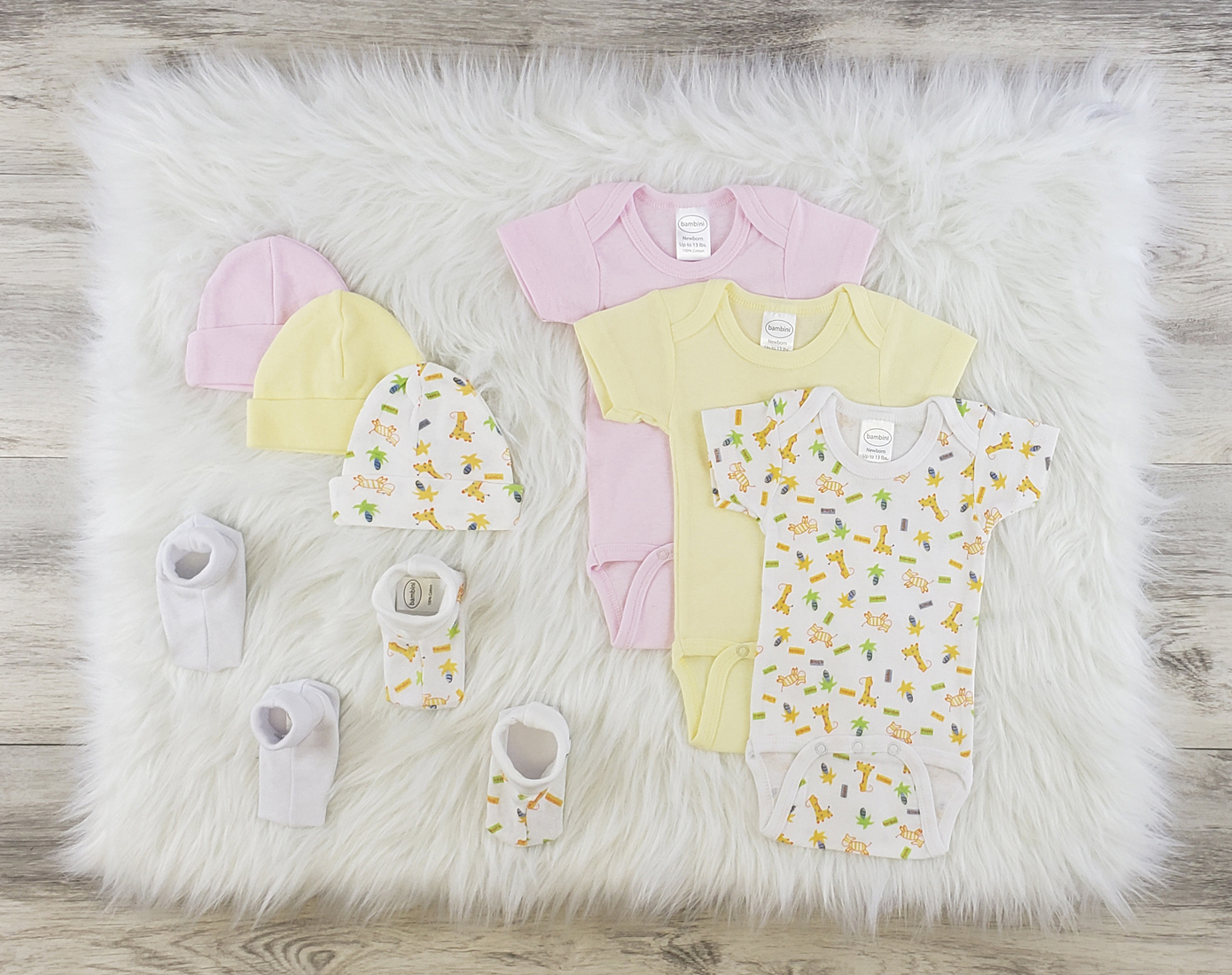 Bambini 8 Pc Layette Baby Clothes Set featuring soft cotton onesies, baby caps, and booties in pastel colors, perfect for newborns.