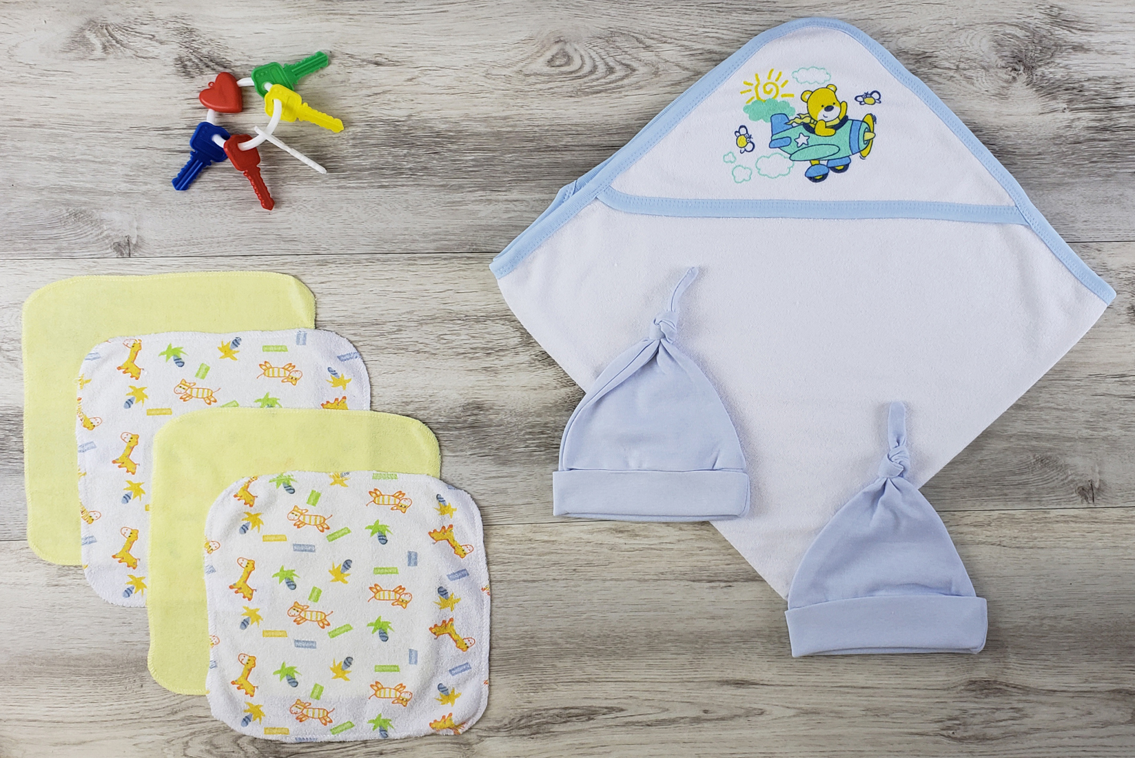 Bambini Hooded Towel set featuring soft cotton towel, blue knotted cap, and wash cloths, perfect for newborns.