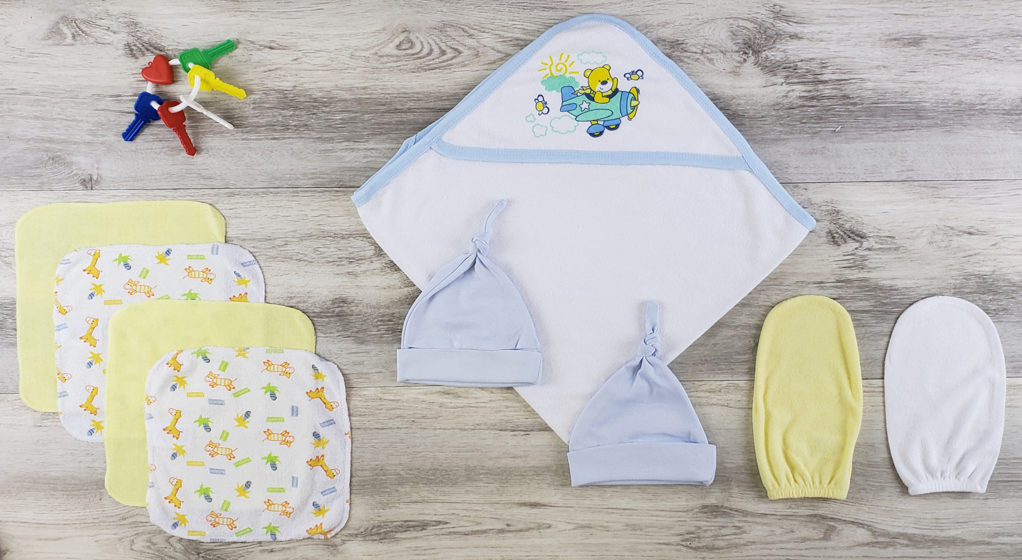 Bambini Hooded Towel set featuring soft cotton towel, blue knotted baby cap, and wash cloths, ideal for newborns.