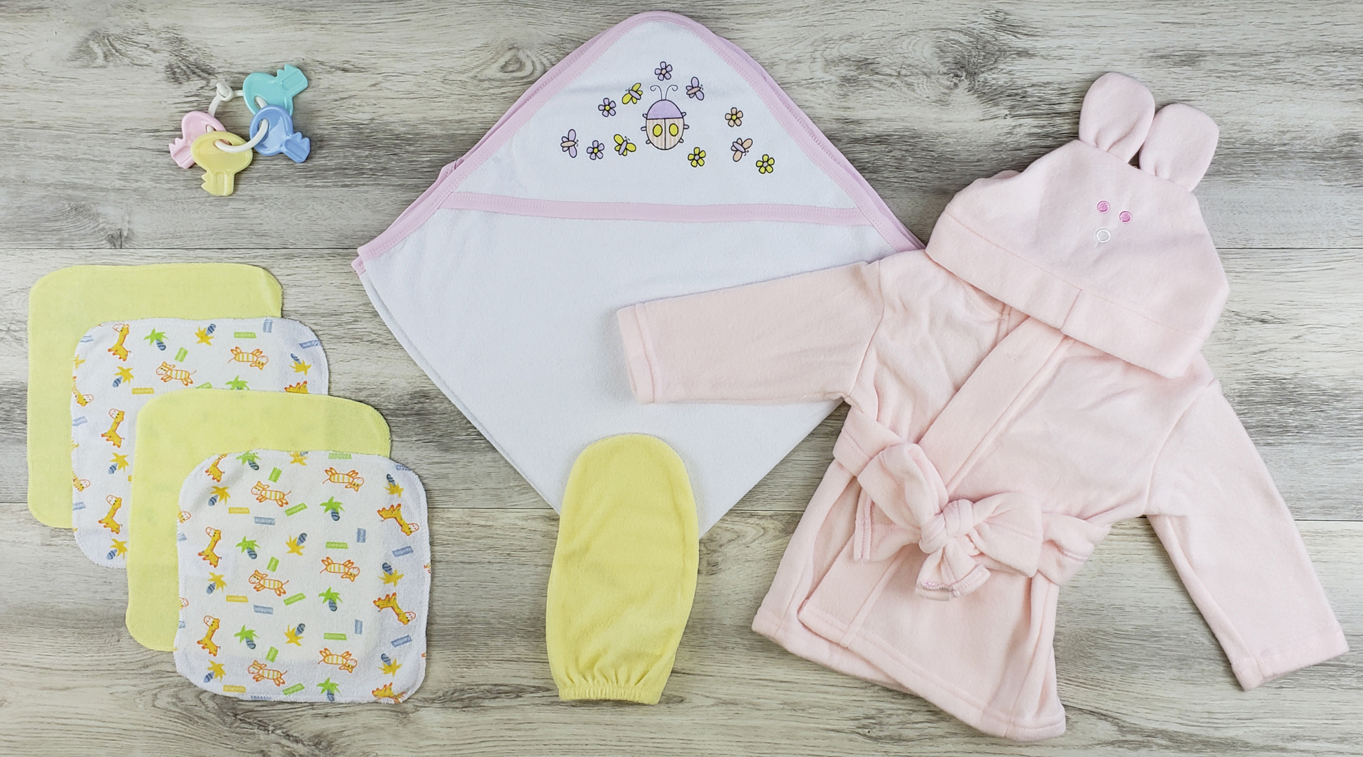 Bambini Hooded Towel set including a pink fleece robe, wash cloths, and bath mittens, designed for newborn comfort.