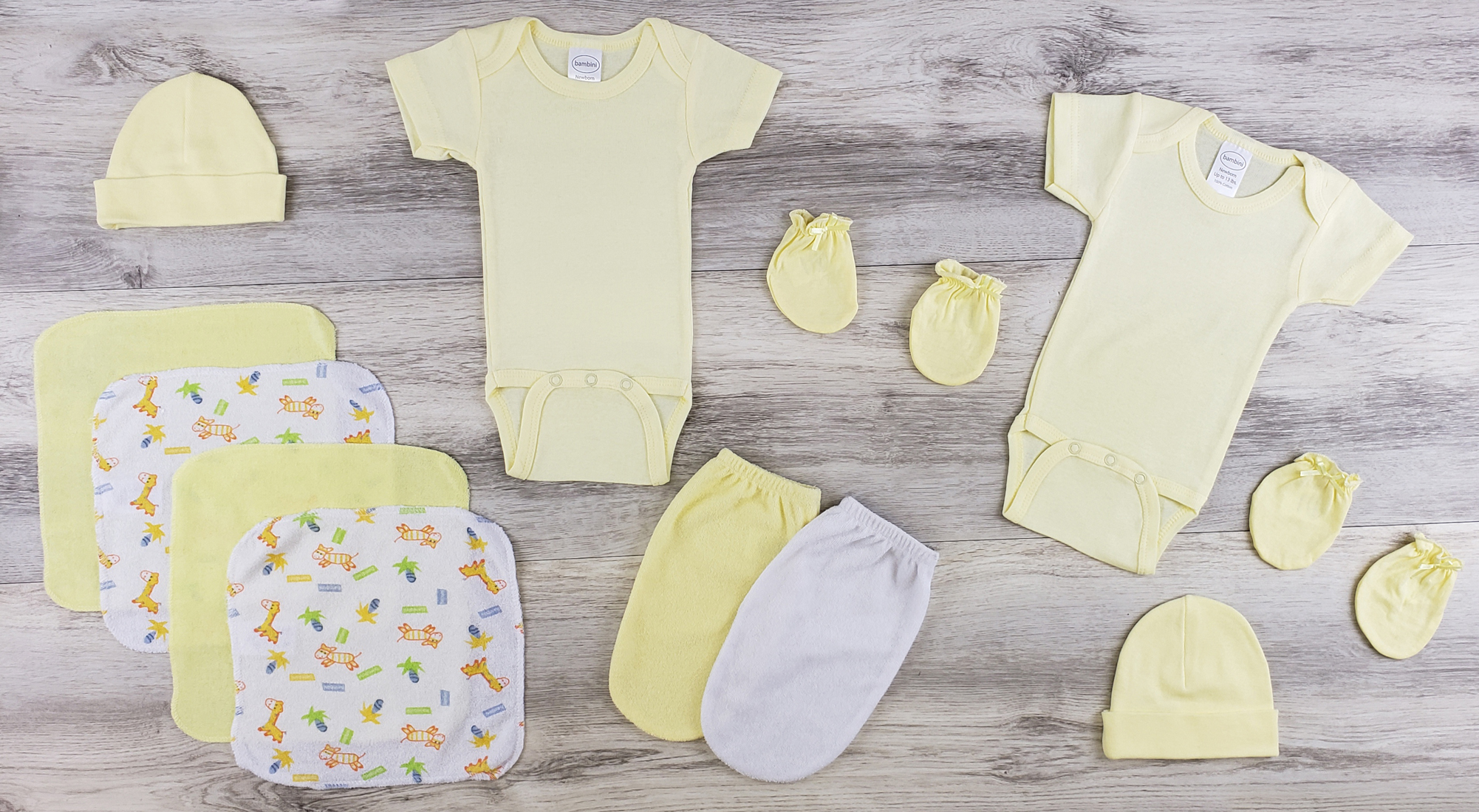 Bambini layette set including yellow onesies, mittens, and hats for newborns, made from soft cotton fabric.