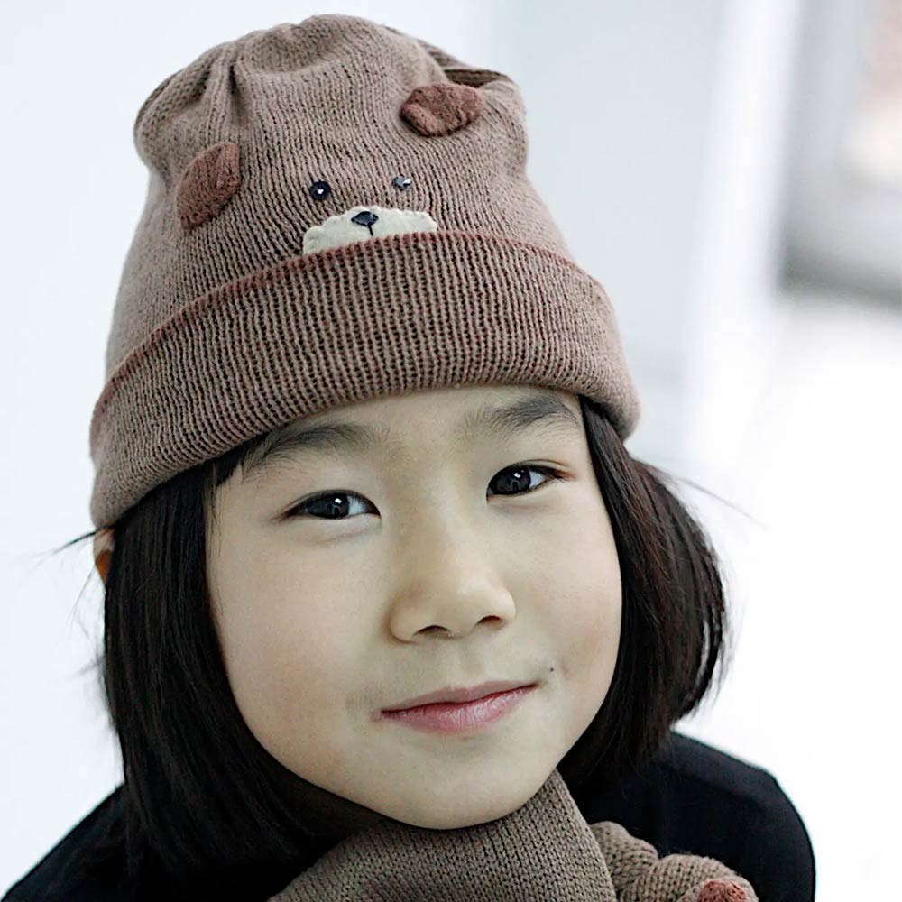 A cozy Bear Knit Hat made from lightweight acrylic, featuring a cute bear design, perfect for winter wear.