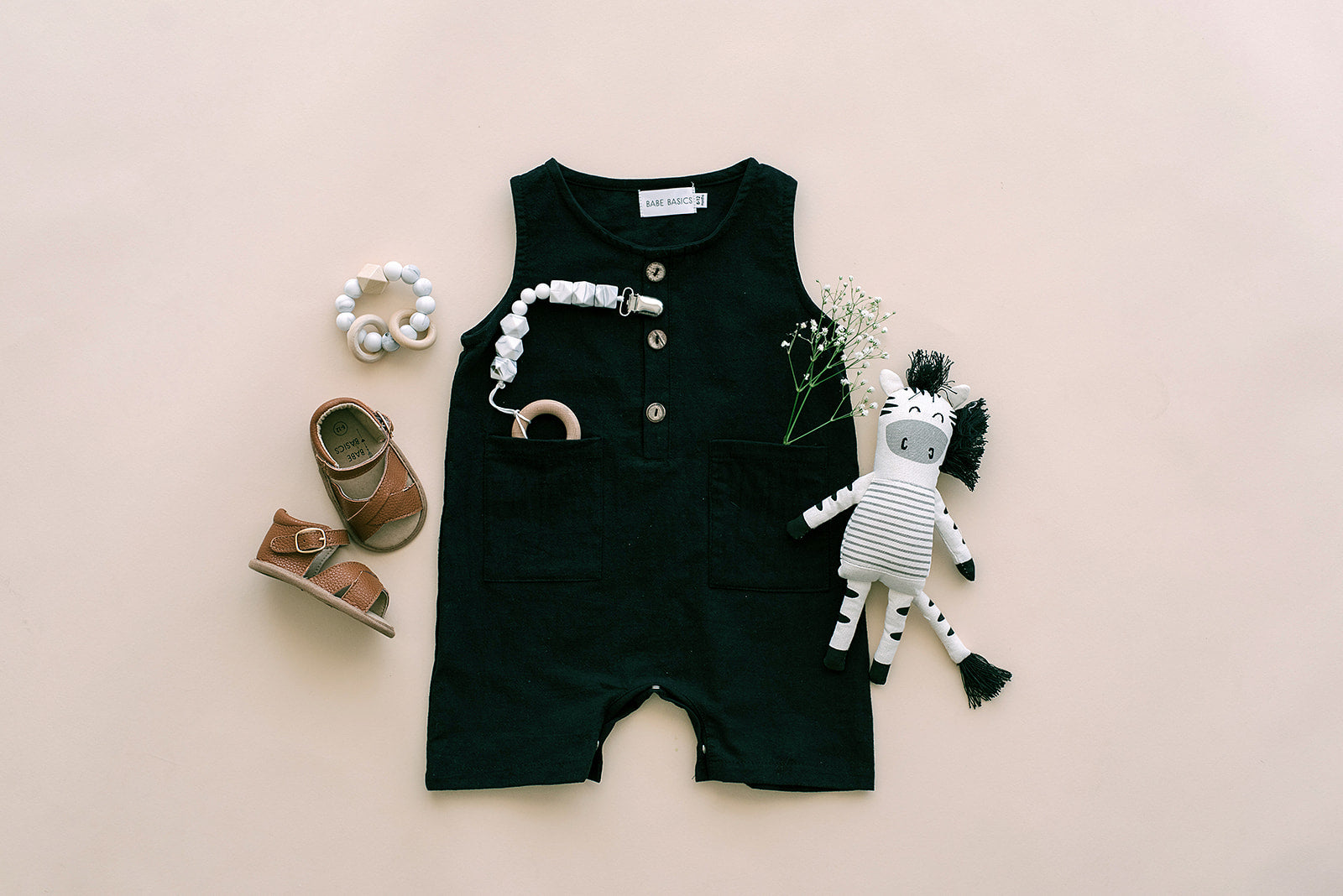 Black cropped linen baby romper with diaper snaps, stylish and breathable for summer wear.