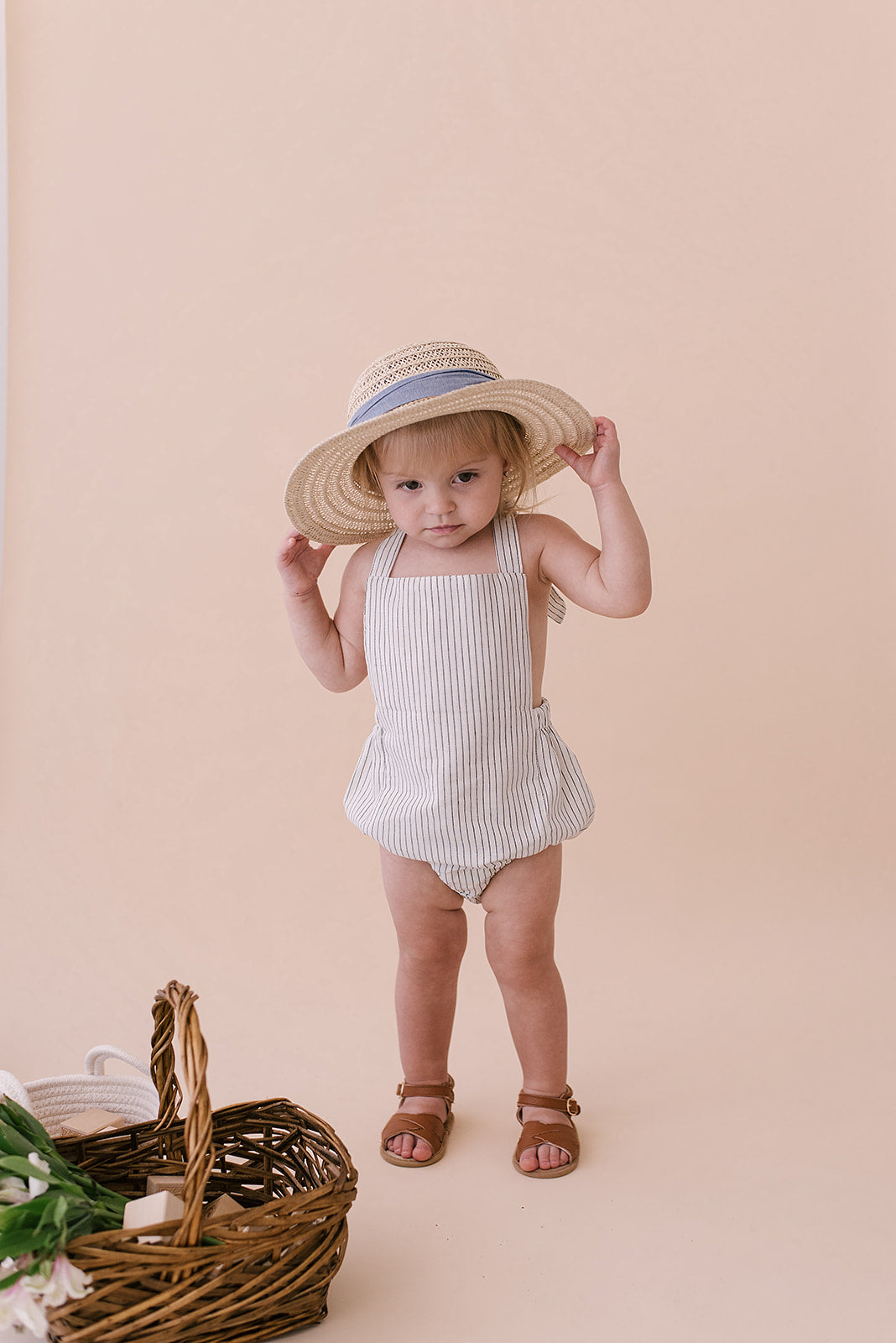 Black & White Striped Halter Romper for babies, featuring a stylish design with easy diaper snaps and made from soft linen fabric.