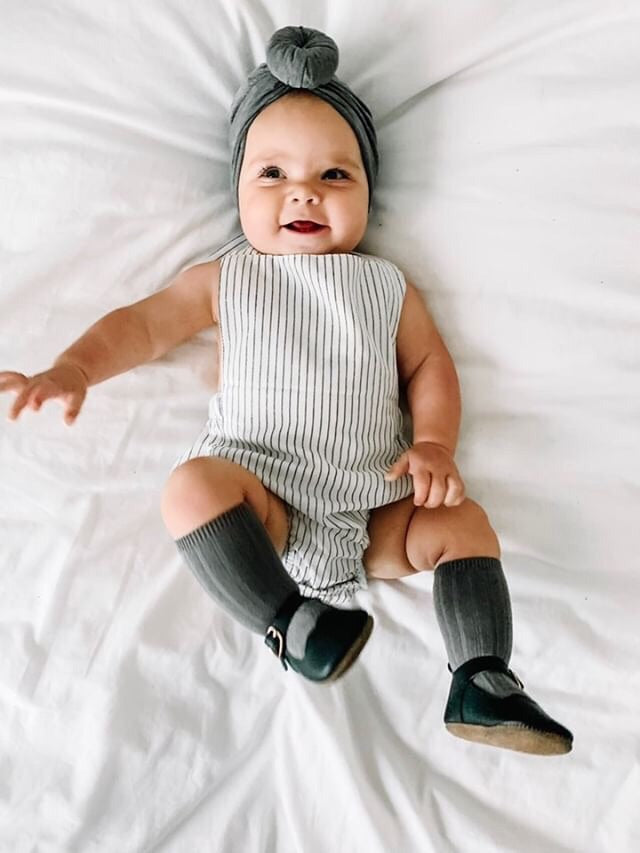 Black & White Striped Halter Romper for babies, featuring a stylish design with easy diaper snaps and made from soft linen fabric.