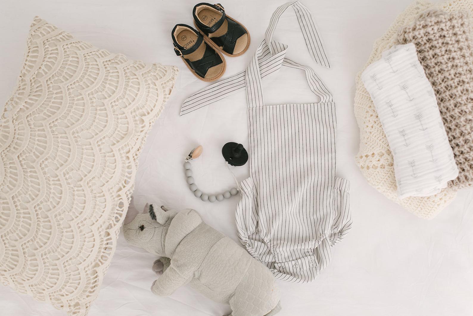 Black & White Striped Halter Romper for babies, featuring a stylish design with easy diaper snaps and made from soft linen fabric.