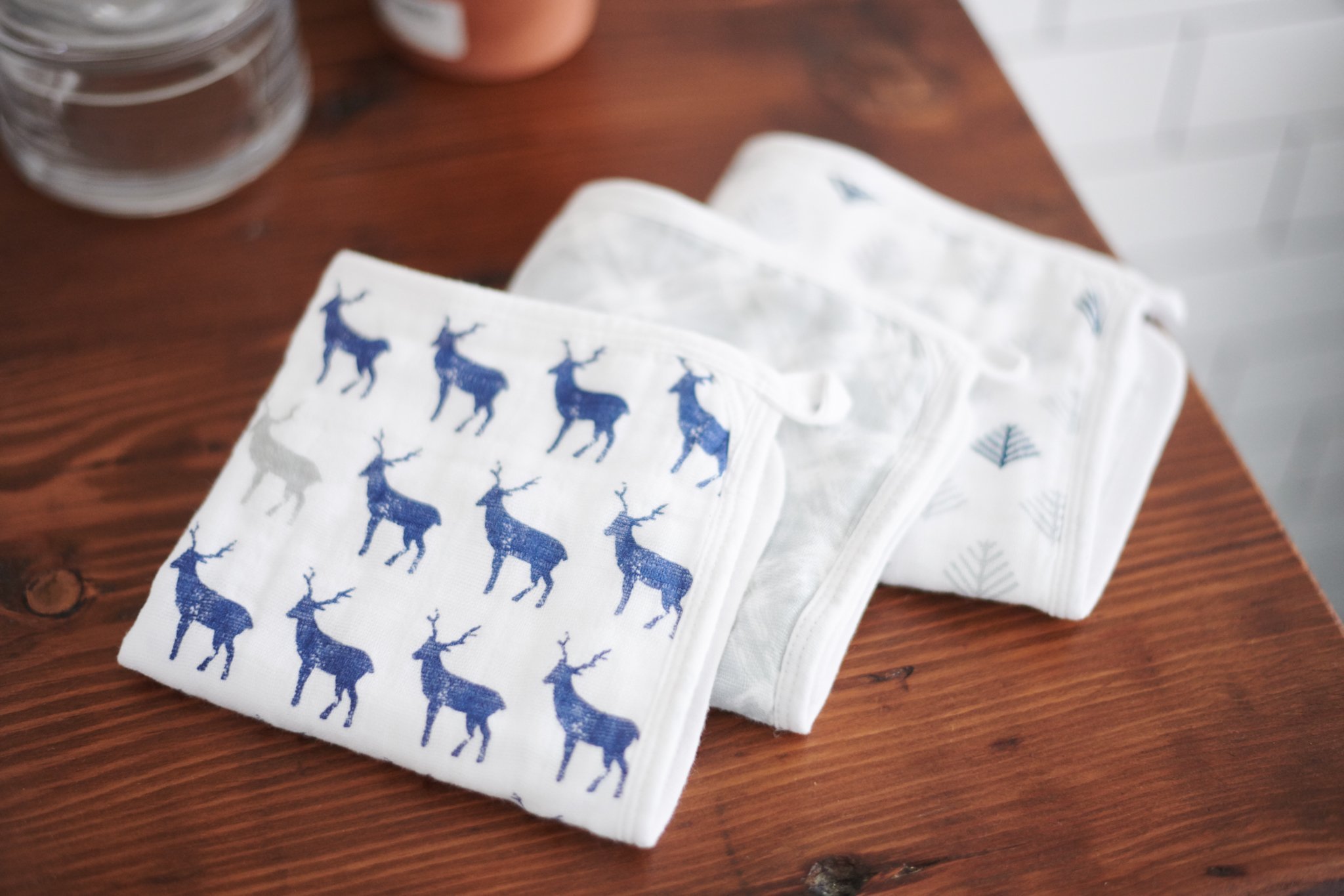 Blue Deer Cotton Washcloth Set 3PK featuring colorful prints and attached loops for drying.