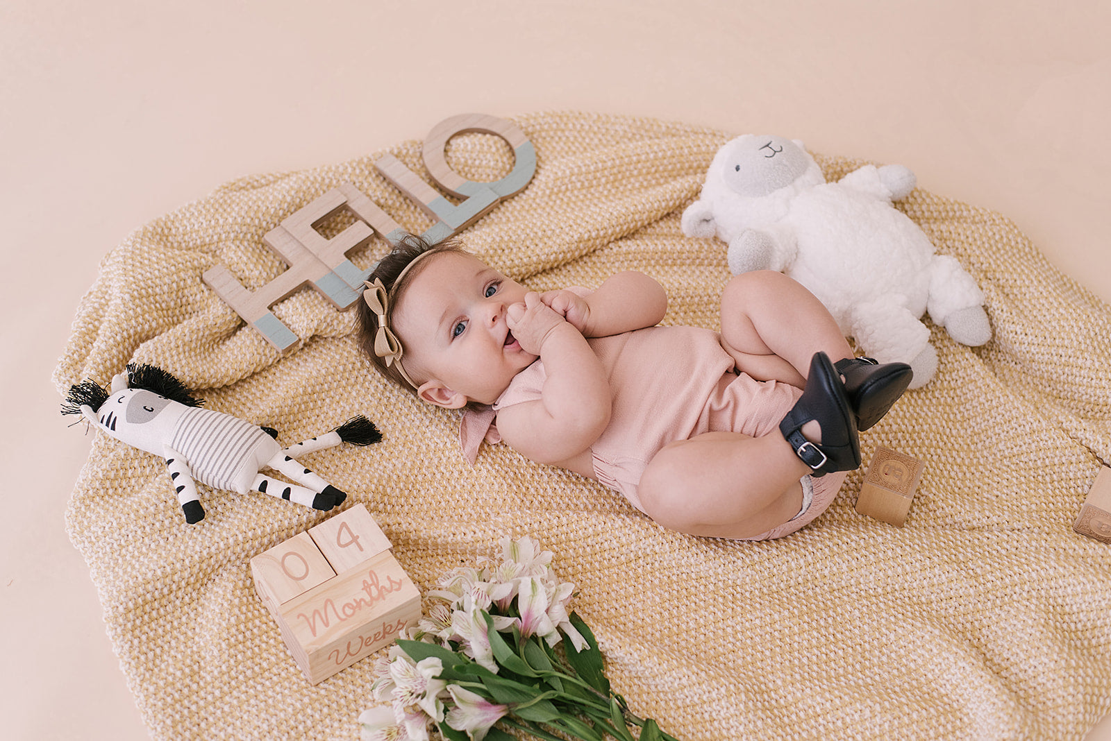 A stylish blush halter romper for babies, made from soft linen with diaper snaps.