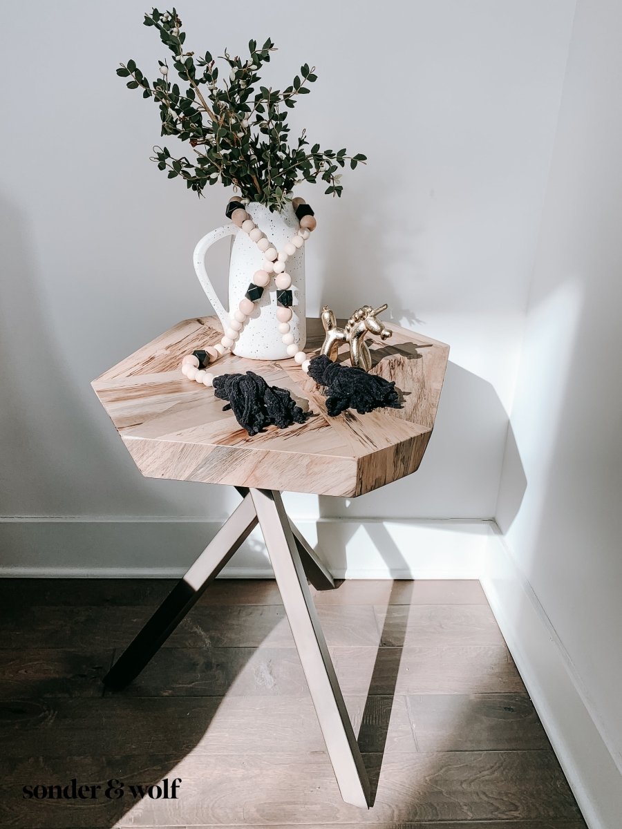 A beautifully handcrafted Boho Wood Bead Garland featuring light unfinished wood beads and stylish black tassels, perfect for home decor.