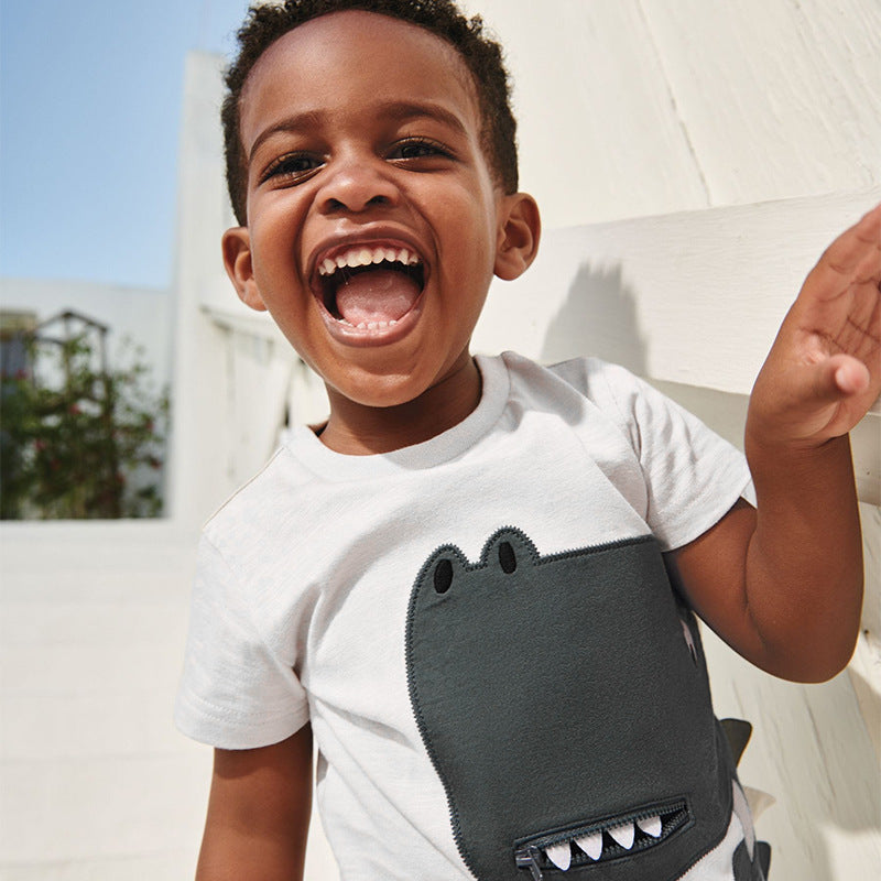 Boys' white dinosaur design t-shirt with pocket, perfect for summer wear.