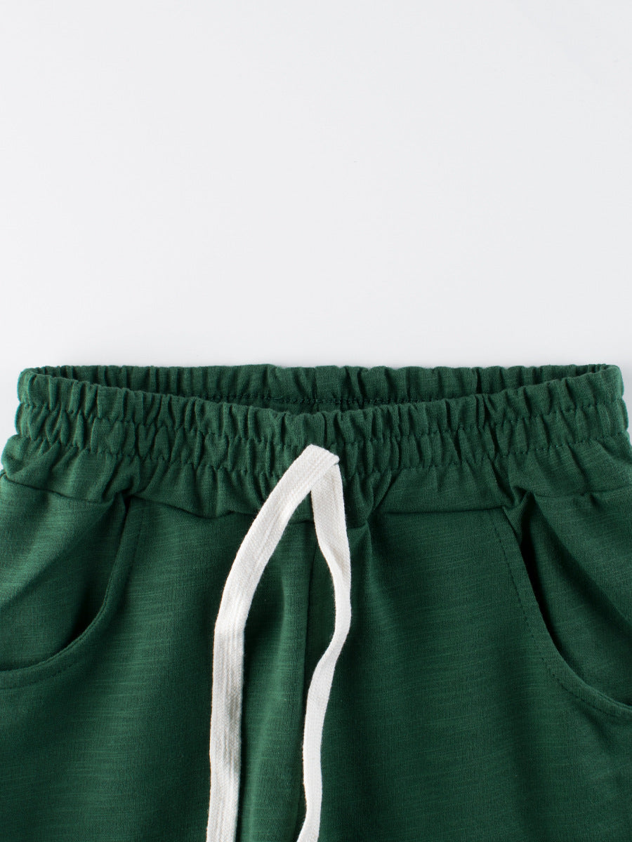 Boys solid color green soft casual style shorts made from cotton, perfect for summer wear, available in various sizes.