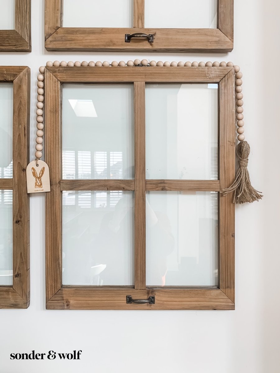 Bunny Wood Bead Garland featuring light wood beads and a jute tassel, perfect for home decor.