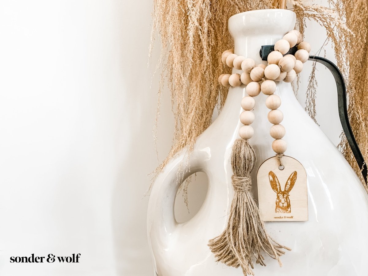 Bunny Wood Bead Garland featuring light wood beads and a jute tassel, perfect for home decor.