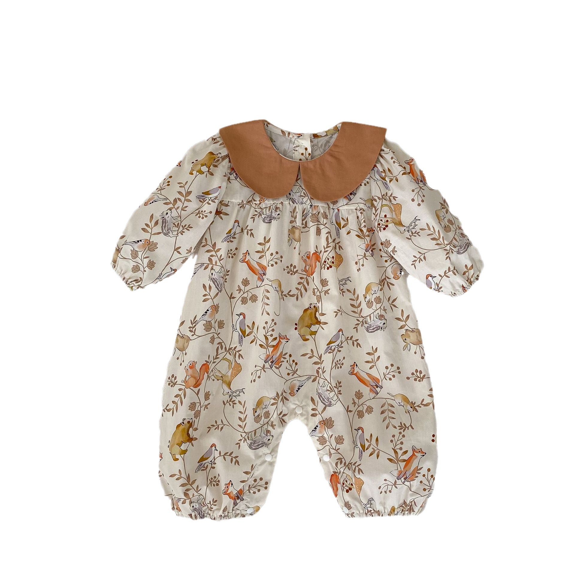 A cute baby girl wearing a Cartoon Graphic Autumn Romper in white with floral patterns, perfect for autumn fashion.