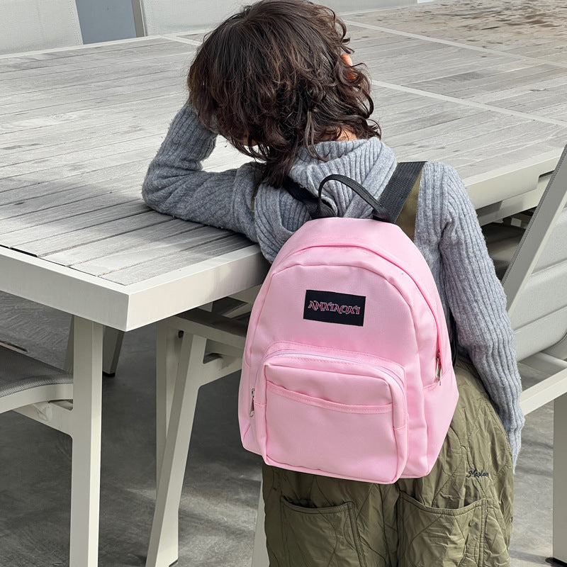 Children's lightweight canvas backpack in various colors, designed for ages 3-8, featuring a fun letters pattern.