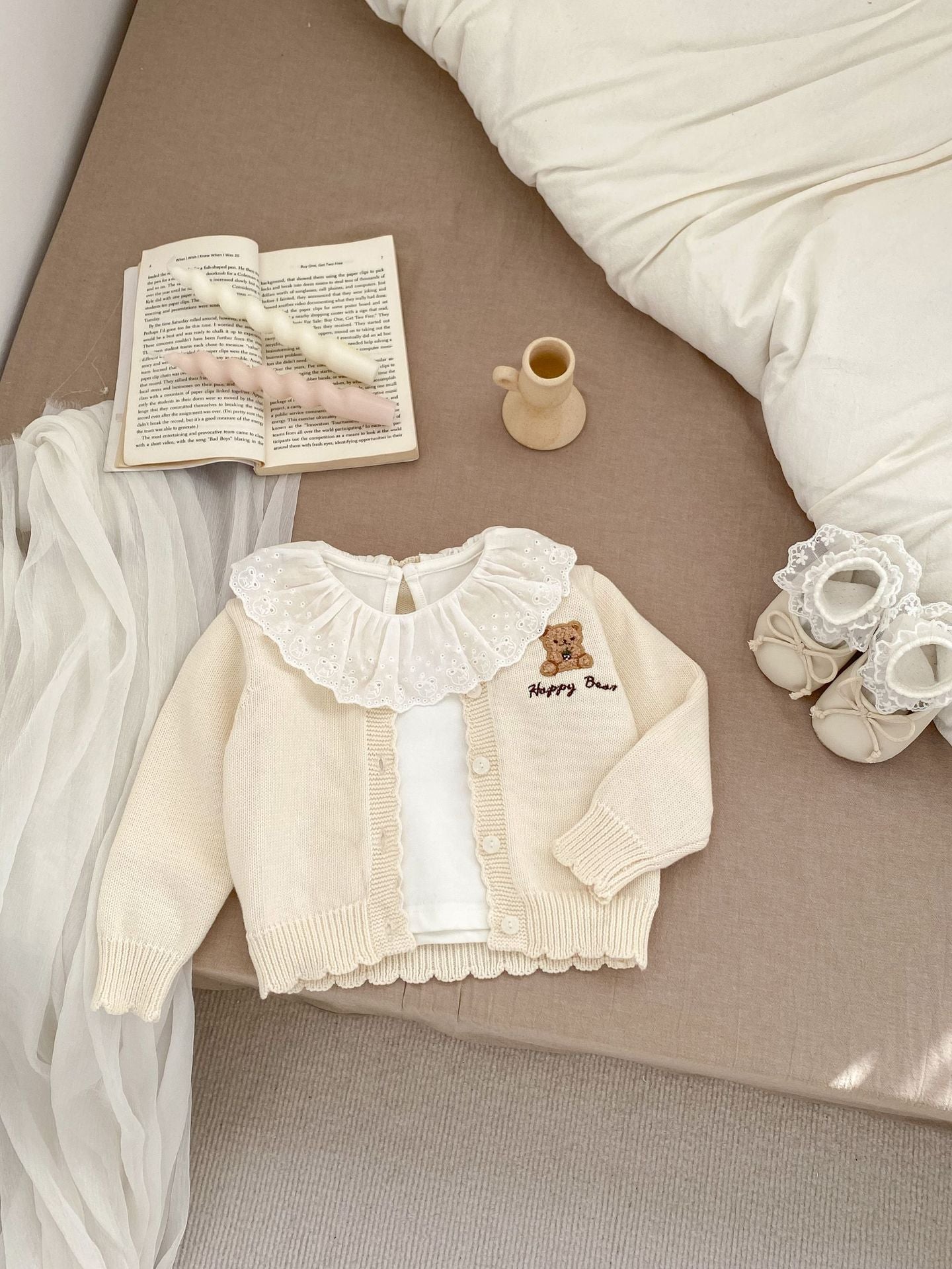 Children's knitted teddy bear cardigan in beige and brown, featuring an embroidered teddy bear design, perfect for spring wear.