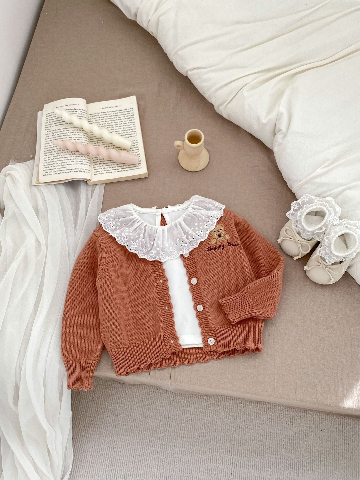 Children's knitted teddy bear cardigan in beige and brown, featuring an embroidered teddy bear design, perfect for spring wear.