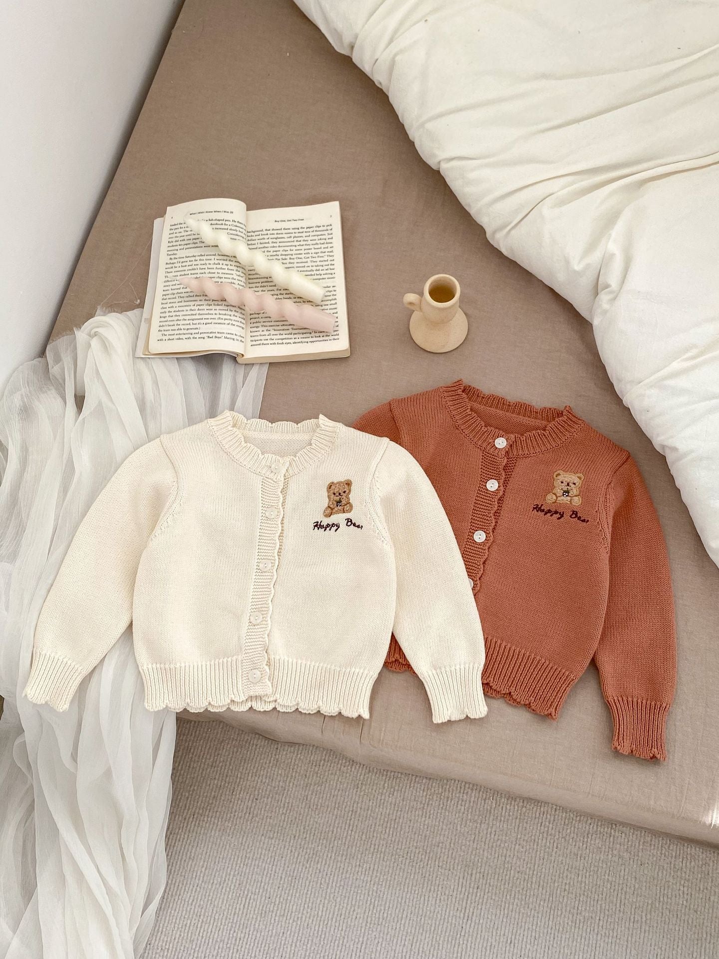 Children's knitted teddy bear cardigan in beige and brown, featuring an embroidered teddy bear design, perfect for spring wear.