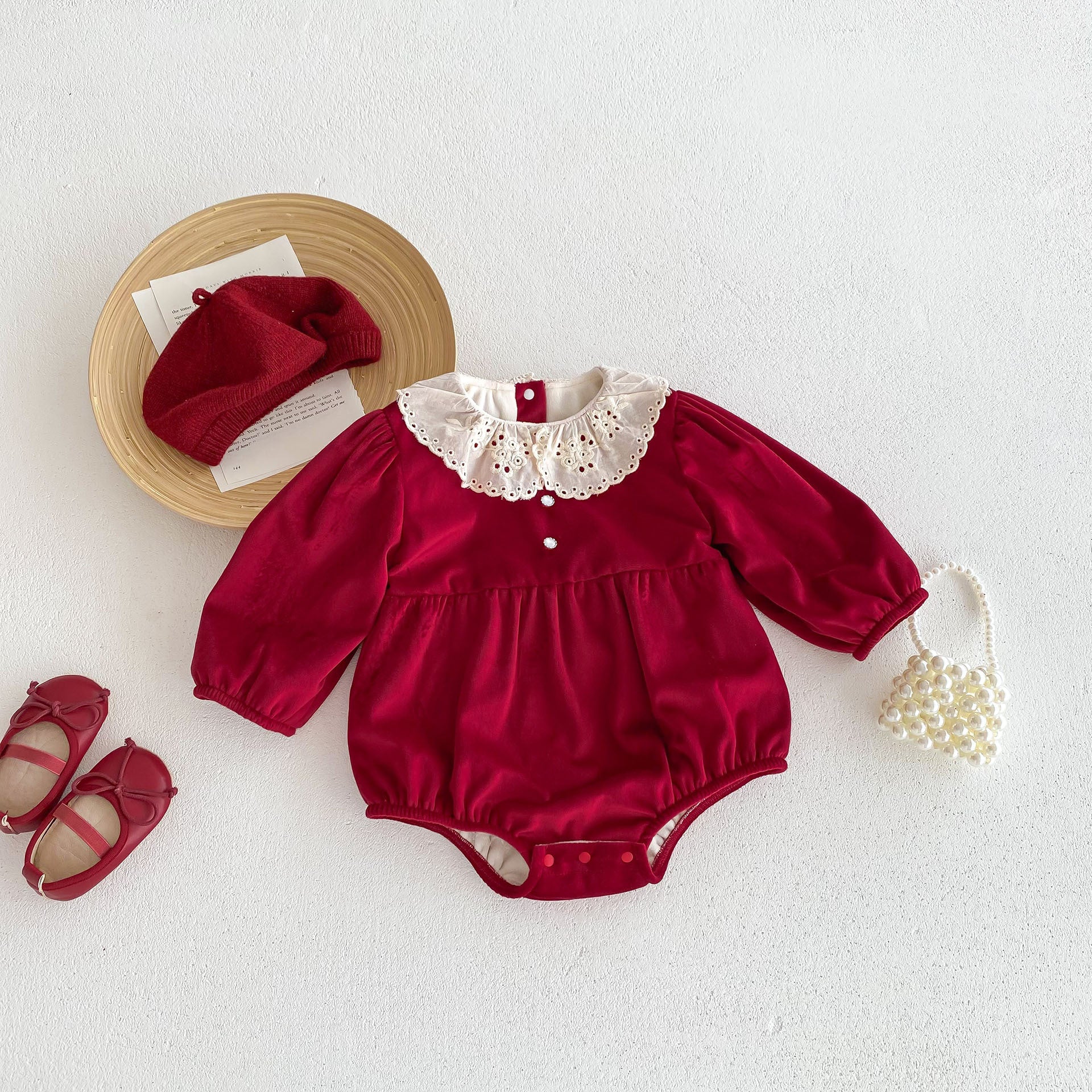 A vibrant red Christmas one-piece for baby girls featuring a laces round collar, perfect for festive occasions.