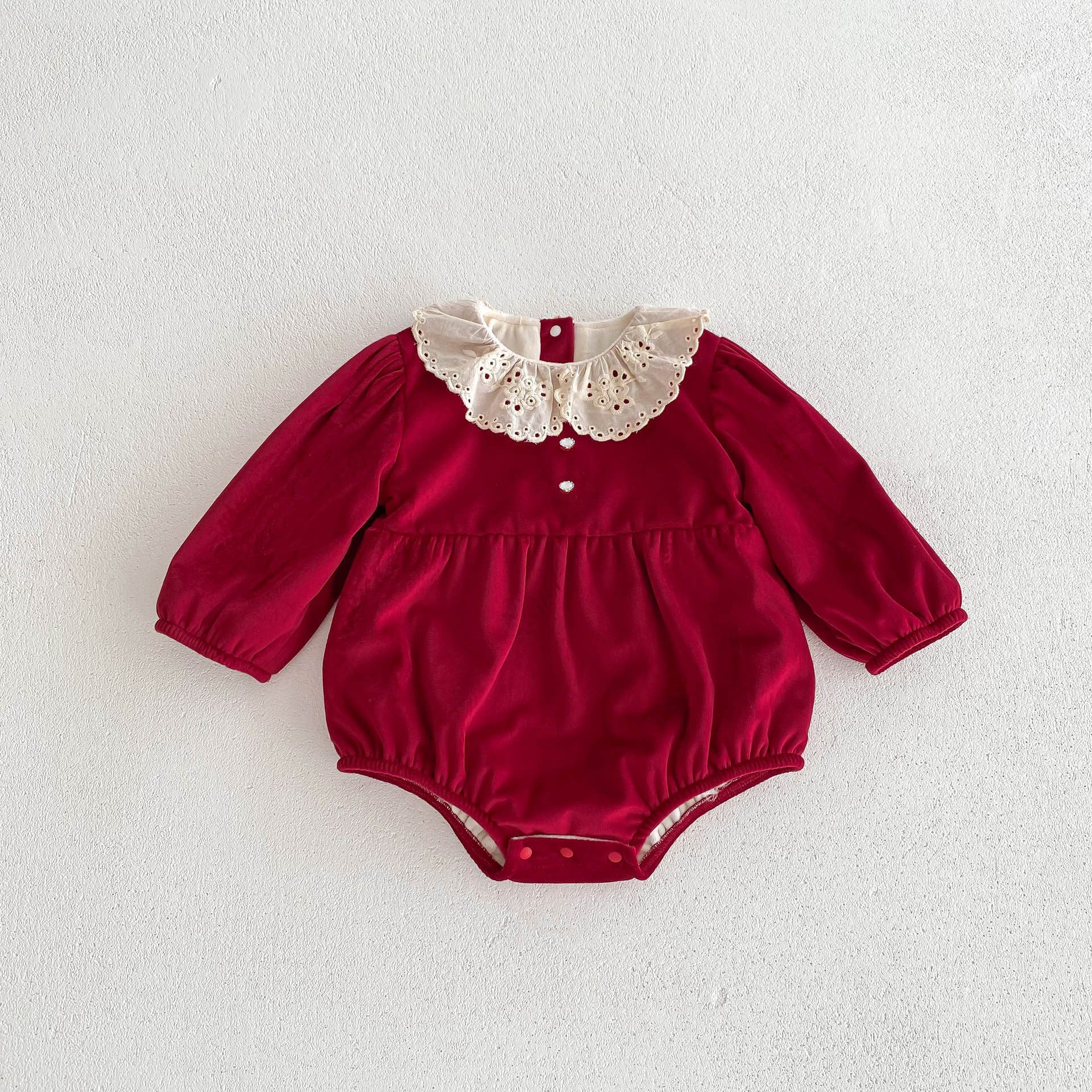 A vibrant red Christmas one-piece for baby girls featuring a laces round collar, perfect for festive occasions.