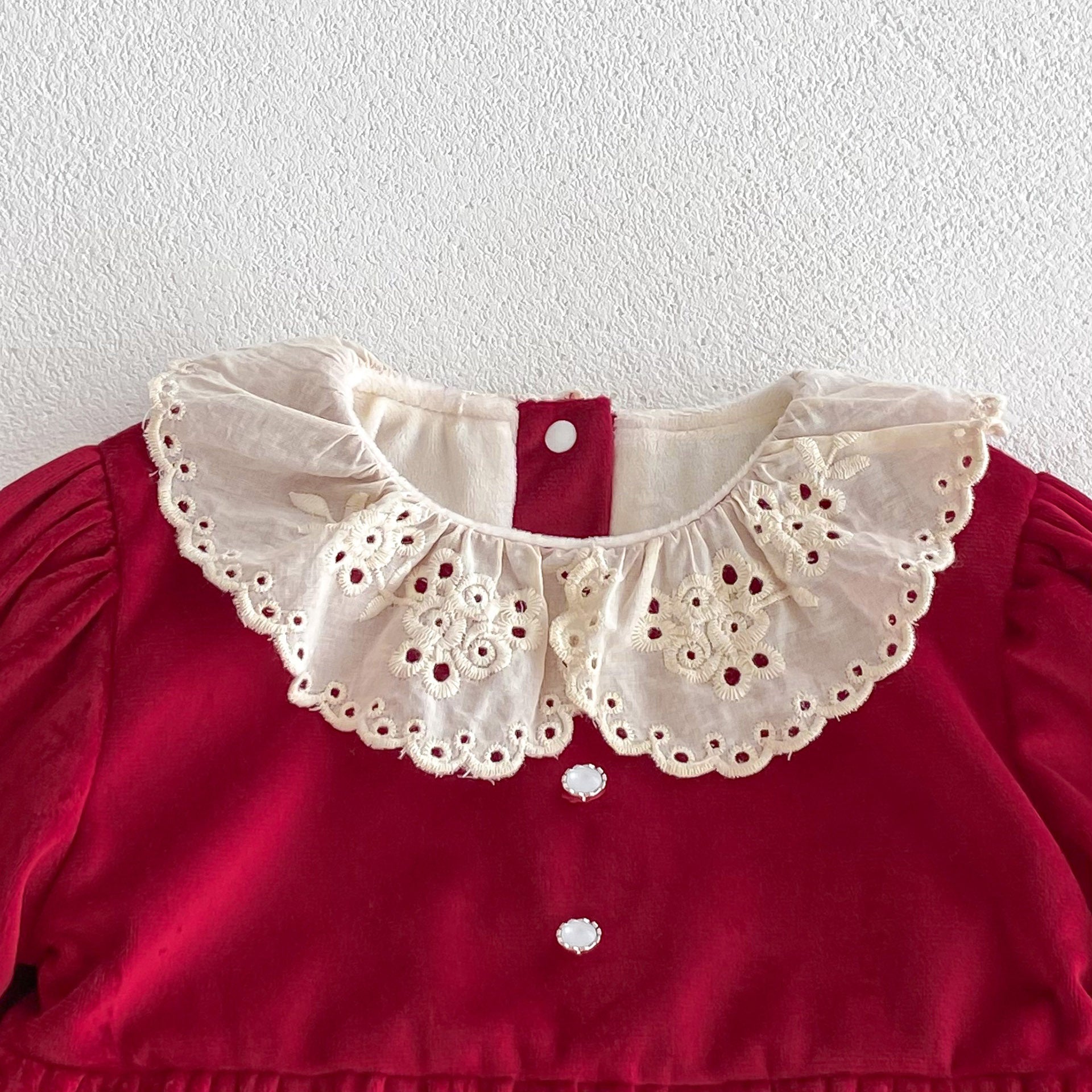 A vibrant red Christmas one-piece for baby girls featuring a laces round collar, perfect for festive occasions.