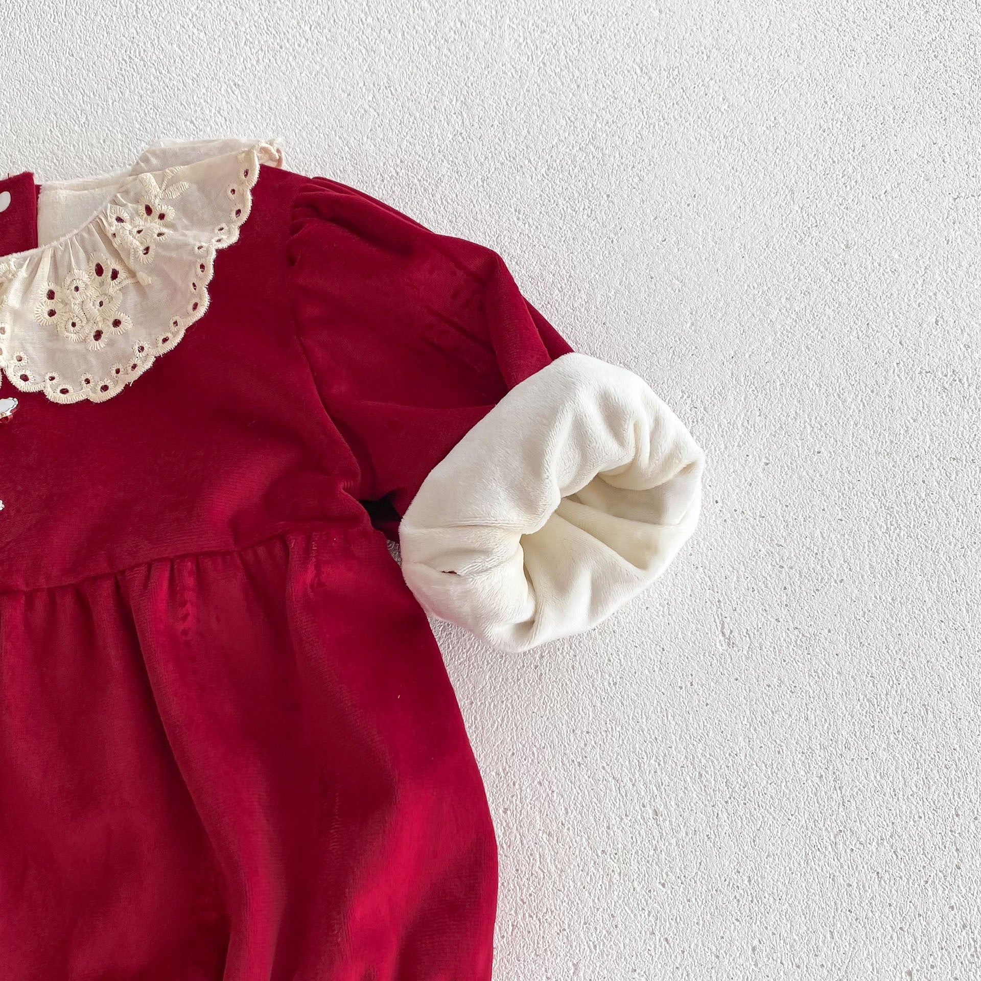 A vibrant red Christmas one-piece for baby girls featuring a laces round collar, perfect for festive occasions.