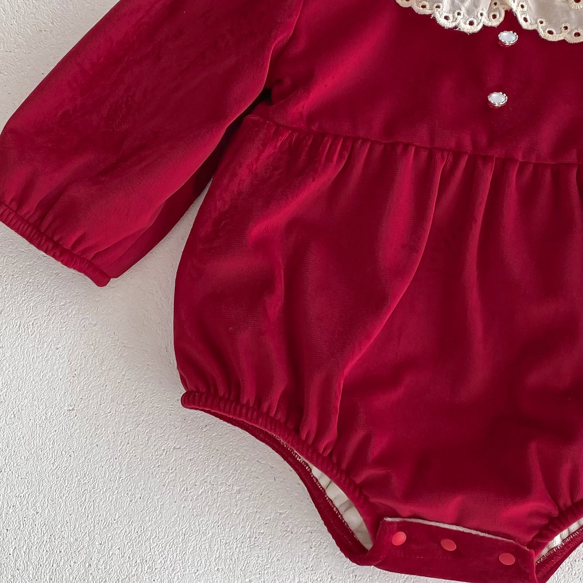 A vibrant red Christmas one-piece for baby girls featuring a laces round collar, perfect for festive occasions.