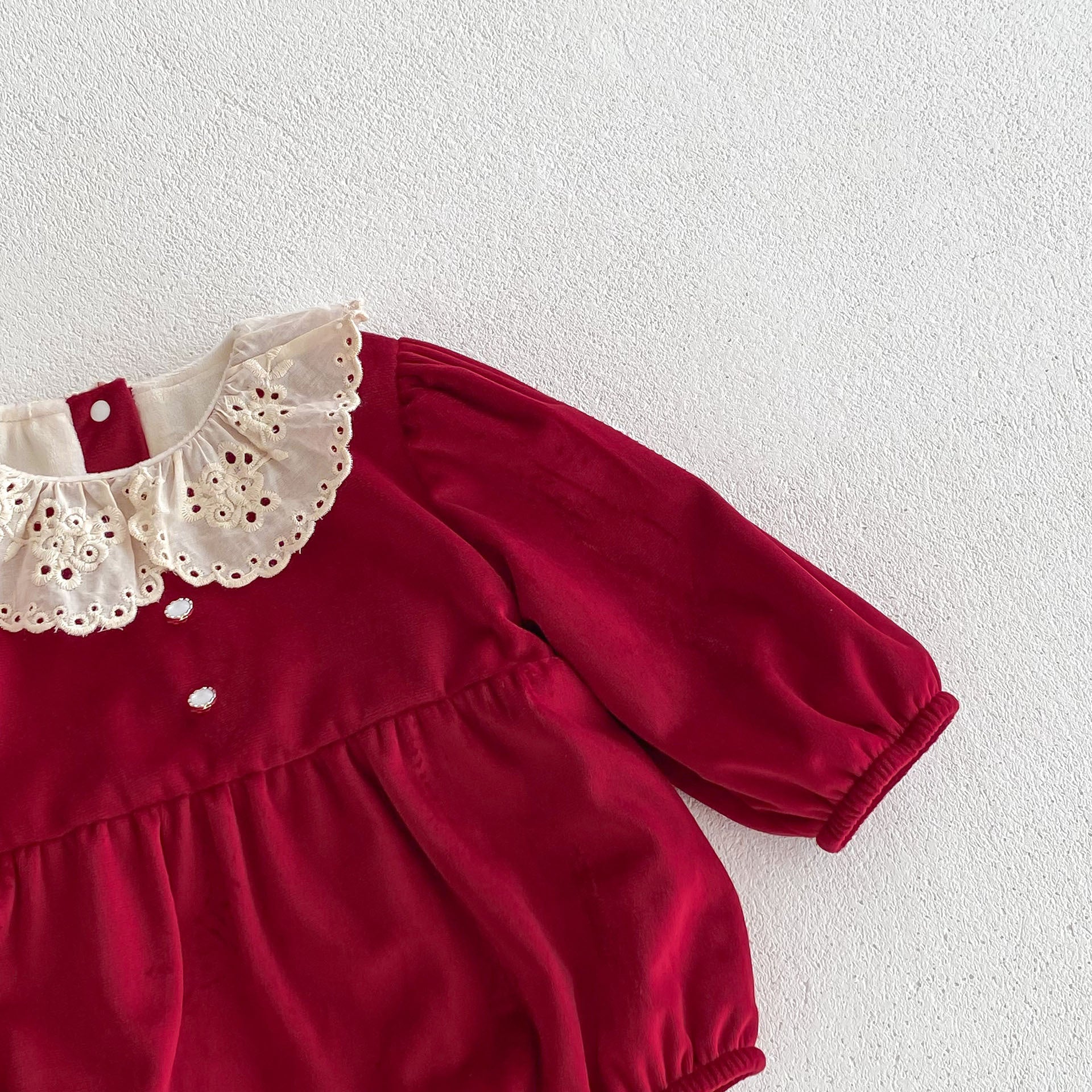 A vibrant red Christmas one-piece for baby girls featuring a laces round collar, perfect for festive occasions.