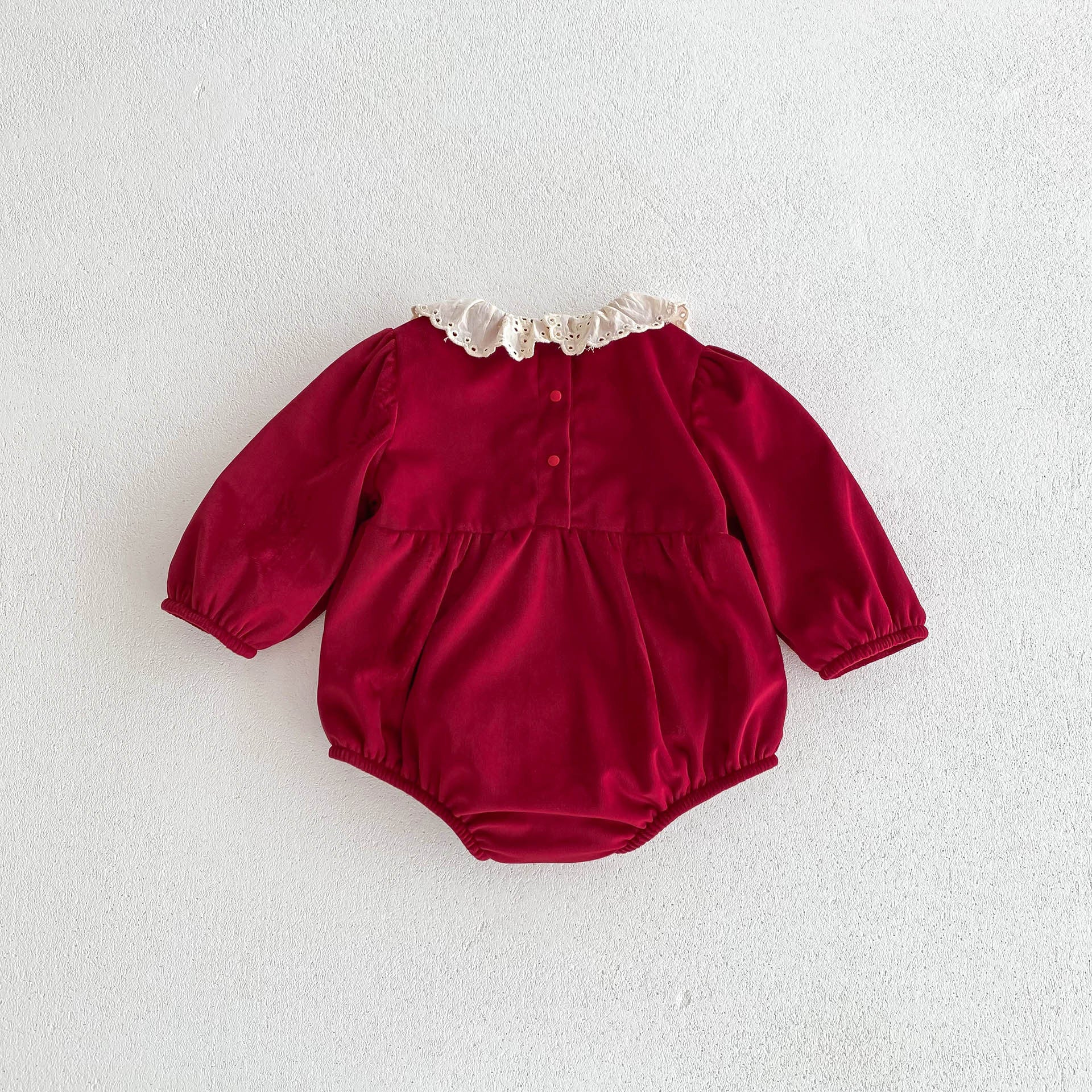 A vibrant red Christmas one-piece for baby girls featuring a laces round collar, perfect for festive occasions.