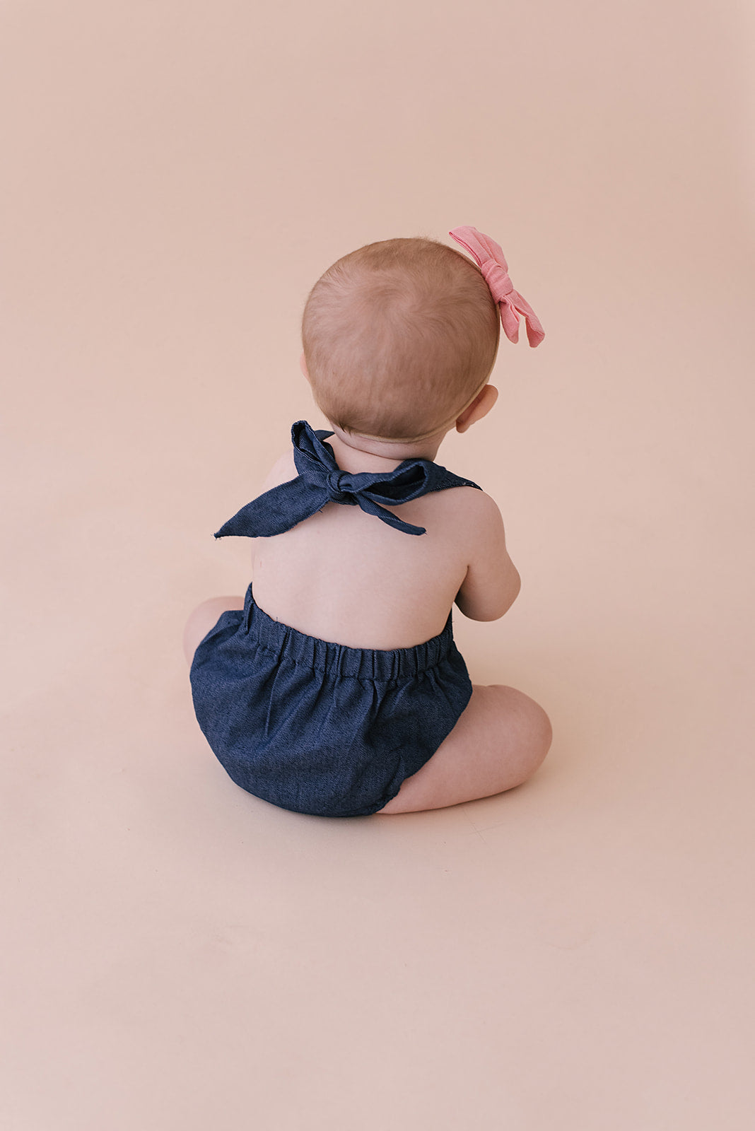 A stylish cobalt halter romper for babies, made from soft linen with diaper snaps.