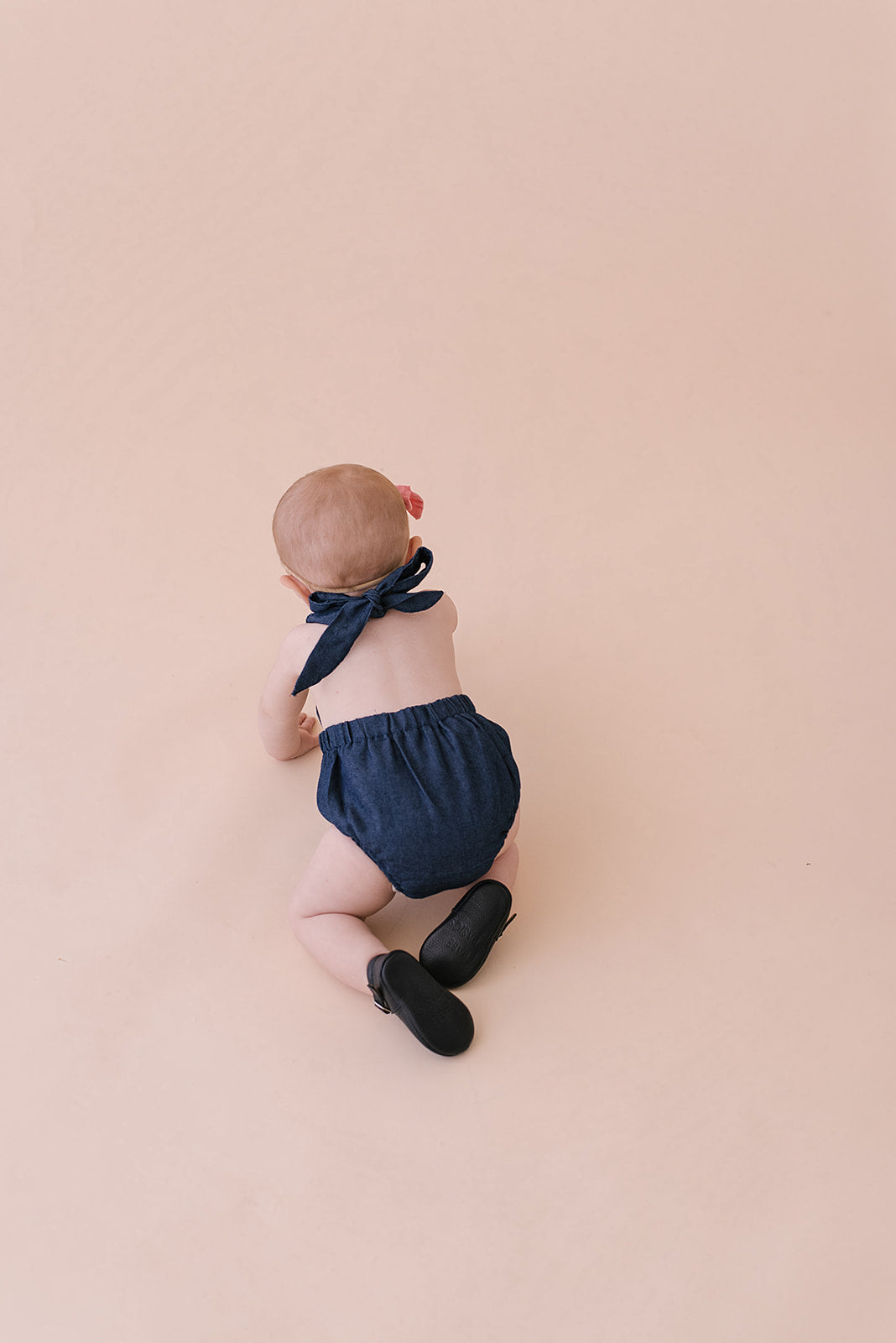 A stylish cobalt halter romper for babies, made from soft linen with diaper snaps.