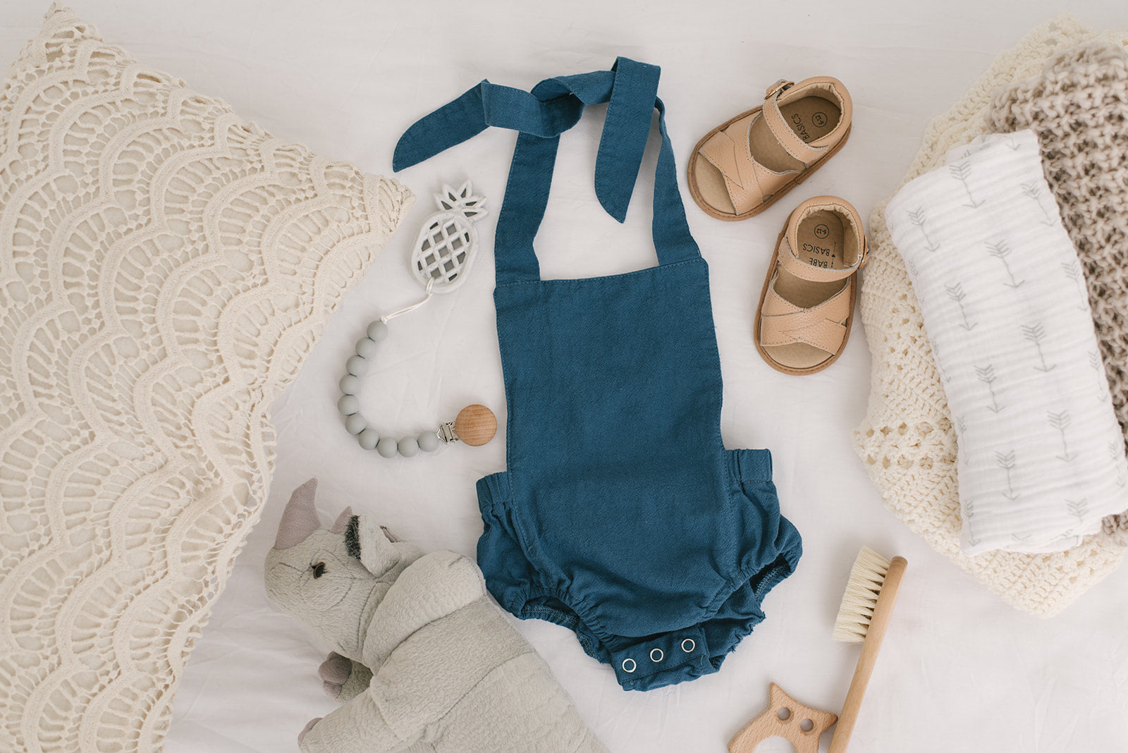 A stylish cobalt halter romper for babies, made from soft linen with diaper snaps.