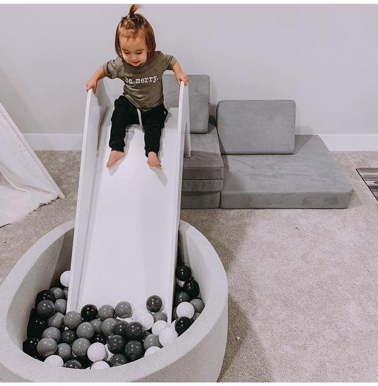 Timeless Pure Oak Handmade Slide in a stylish children's room, showcasing its elegant design and safe features for kids.