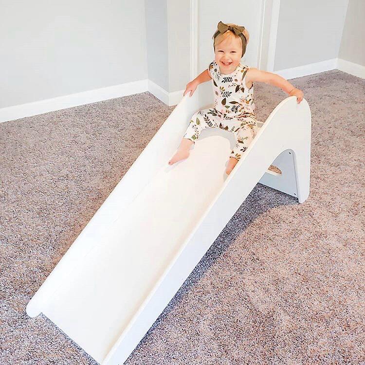 Timeless Pure Oak Handmade Slide in a stylish children's room, showcasing its elegant design and safe features for kids.